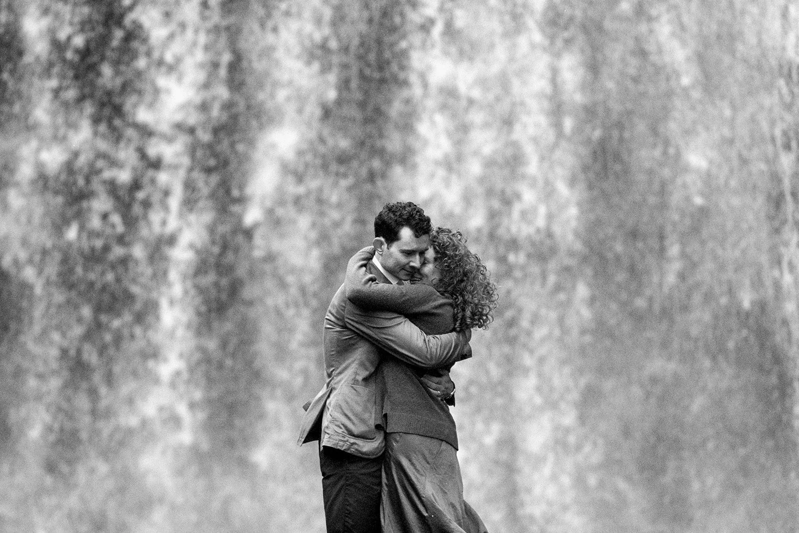 couple embracing in front of looking glass falls on 35mm film