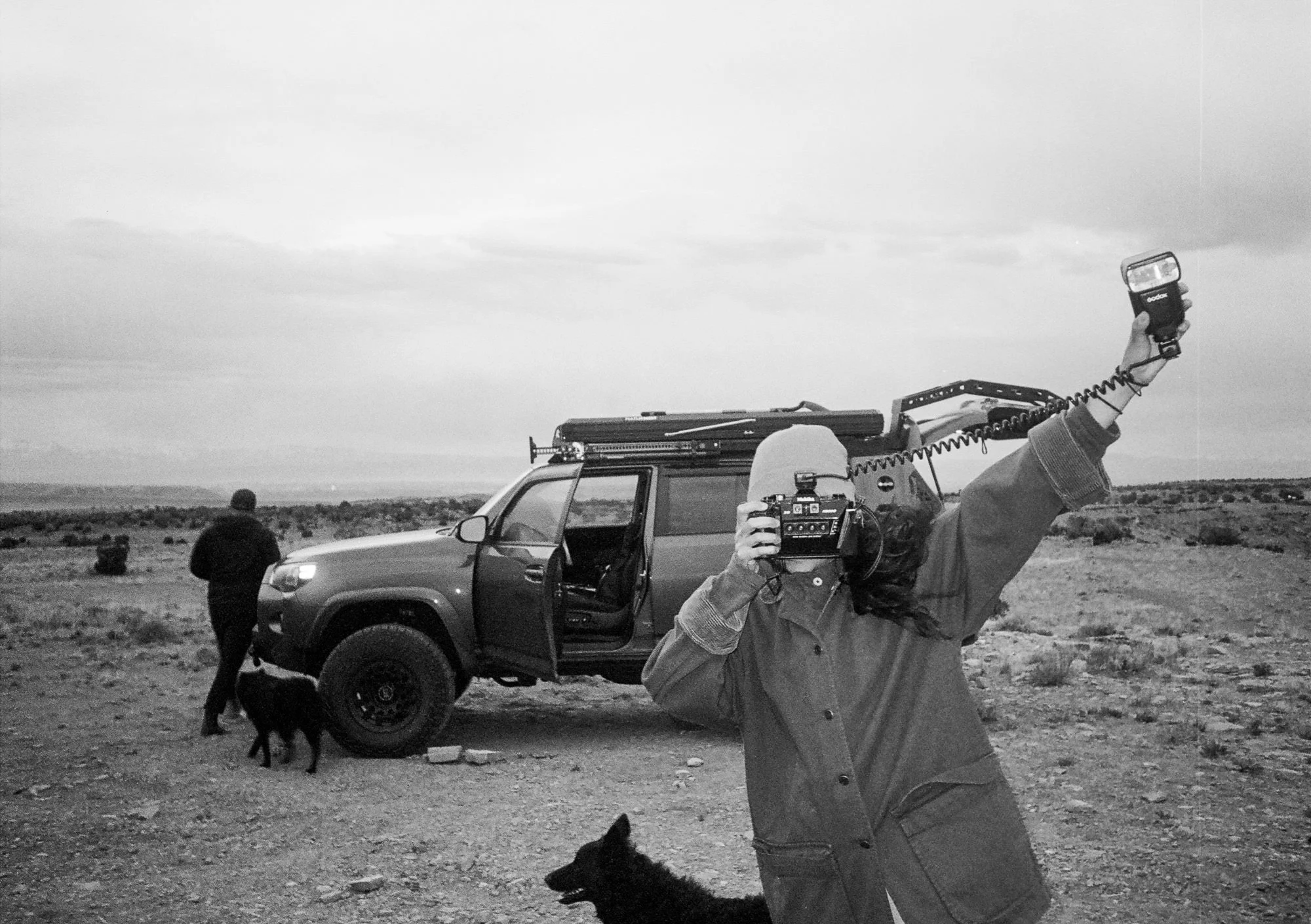 Photographer holding up nishika n8000 camera and flash