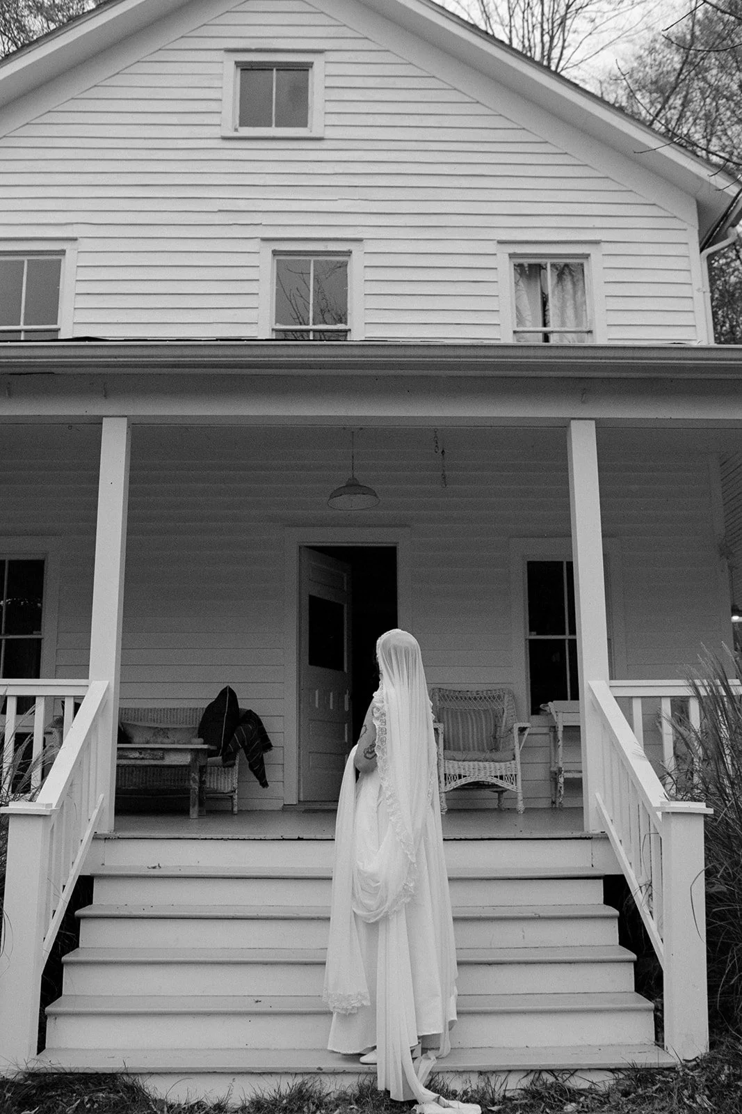 bride on the front steps of farmhouse at handsome hollow