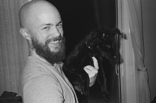 film wedding photographer holding puppy