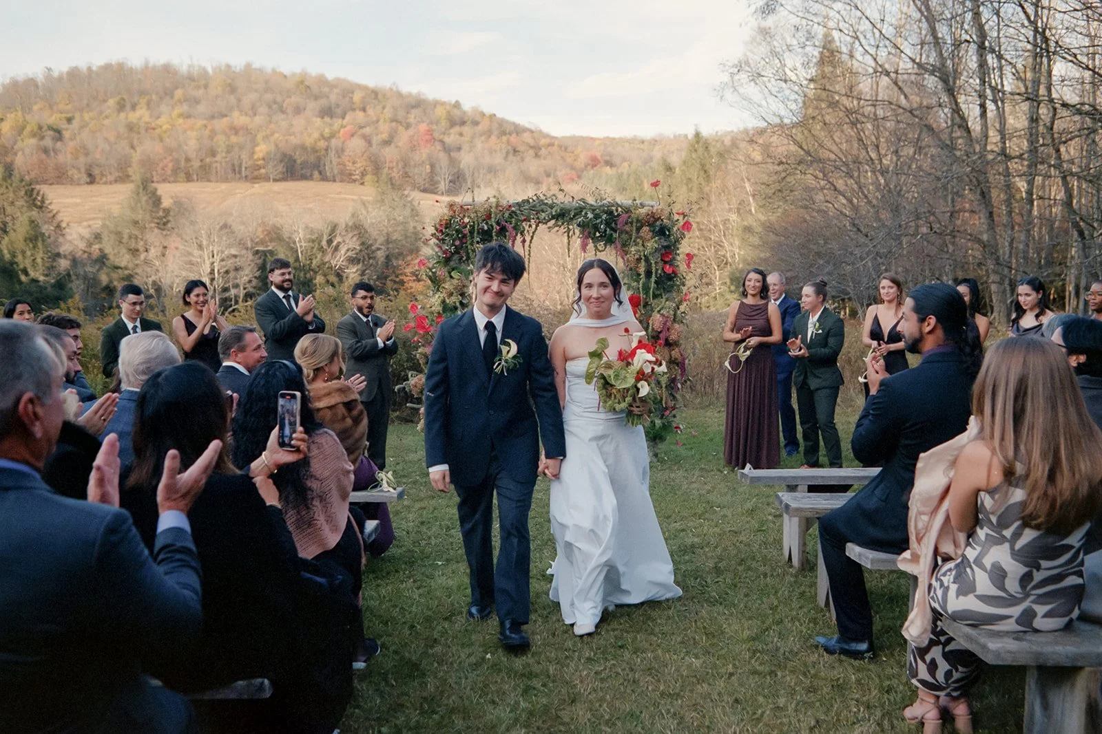 newlyweds walking down the aisle at handsome hollow