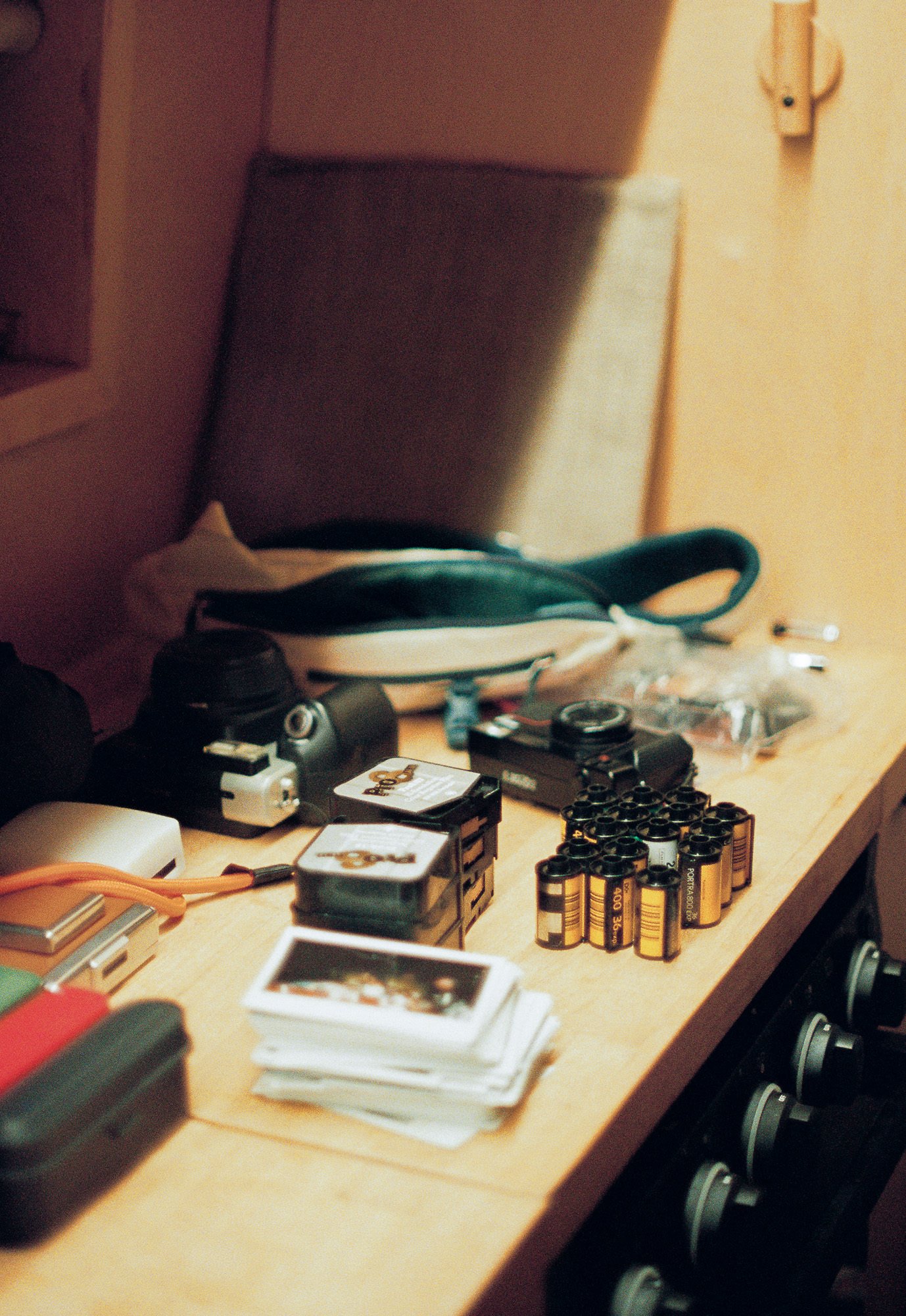 countertop filled with 35mm film and Polaroids and Super 8 film