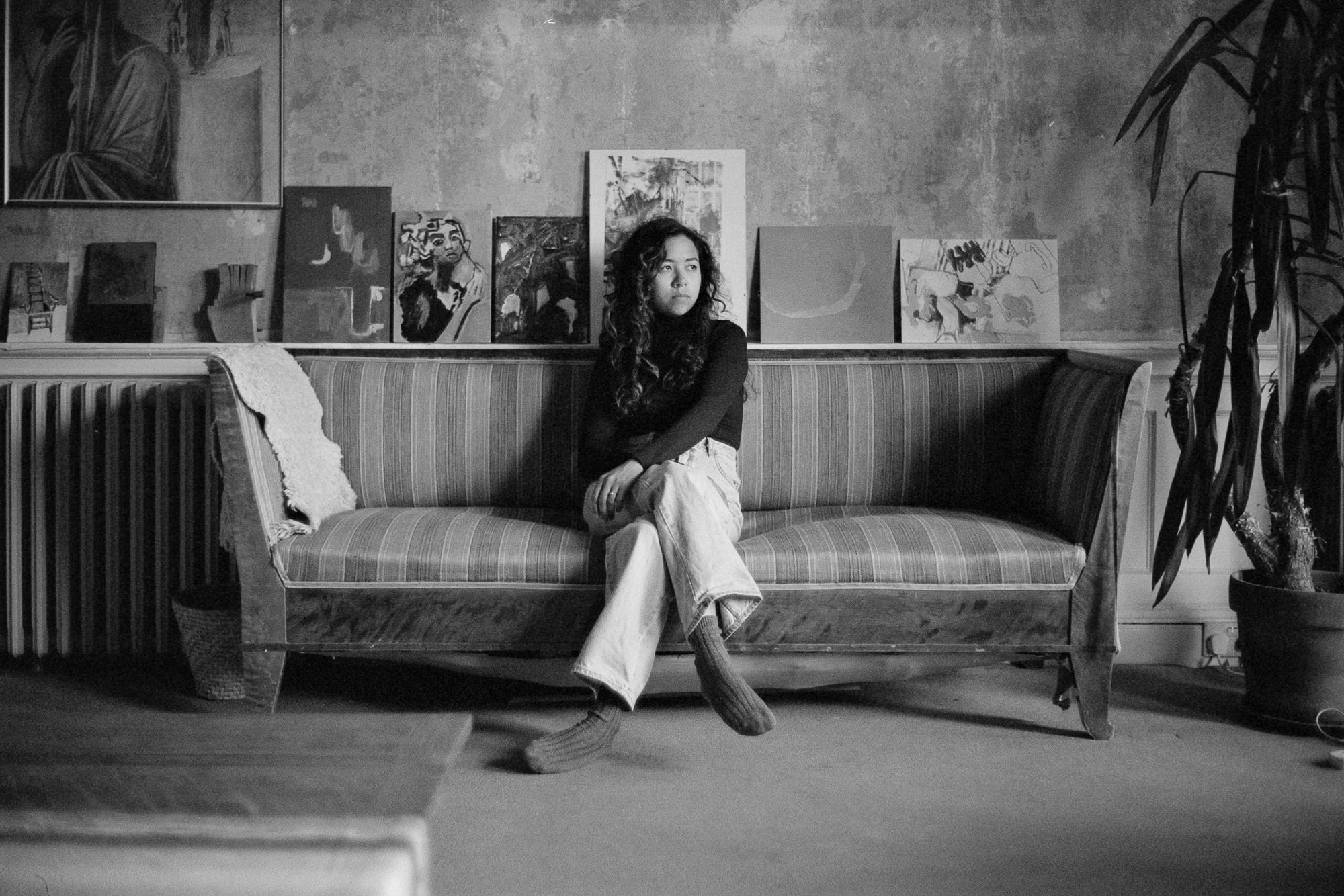 black and white portrait of film wedding photographer sitting on couch