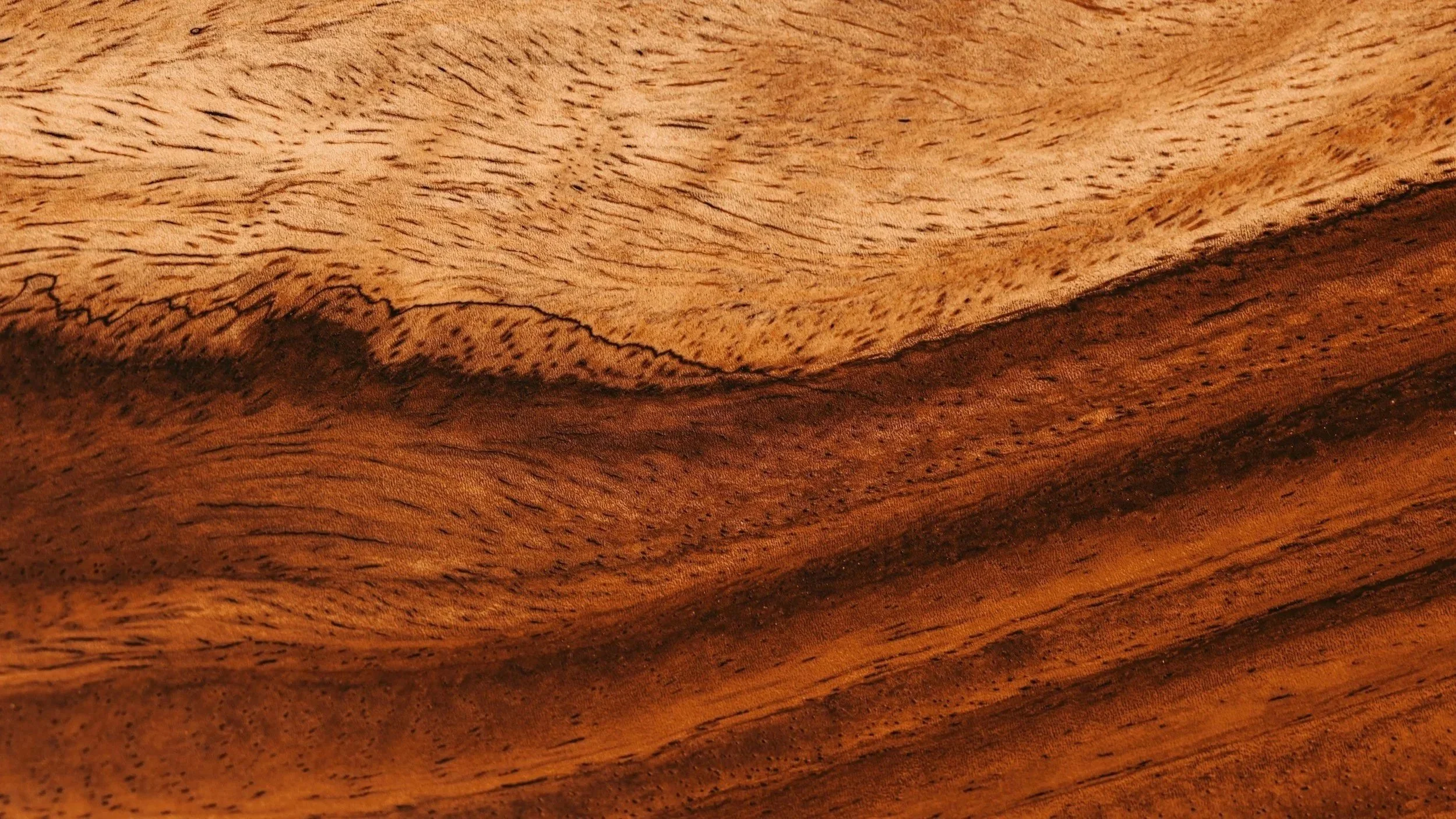 Close-up of textured wooden surface, showing natural grain and color variations.