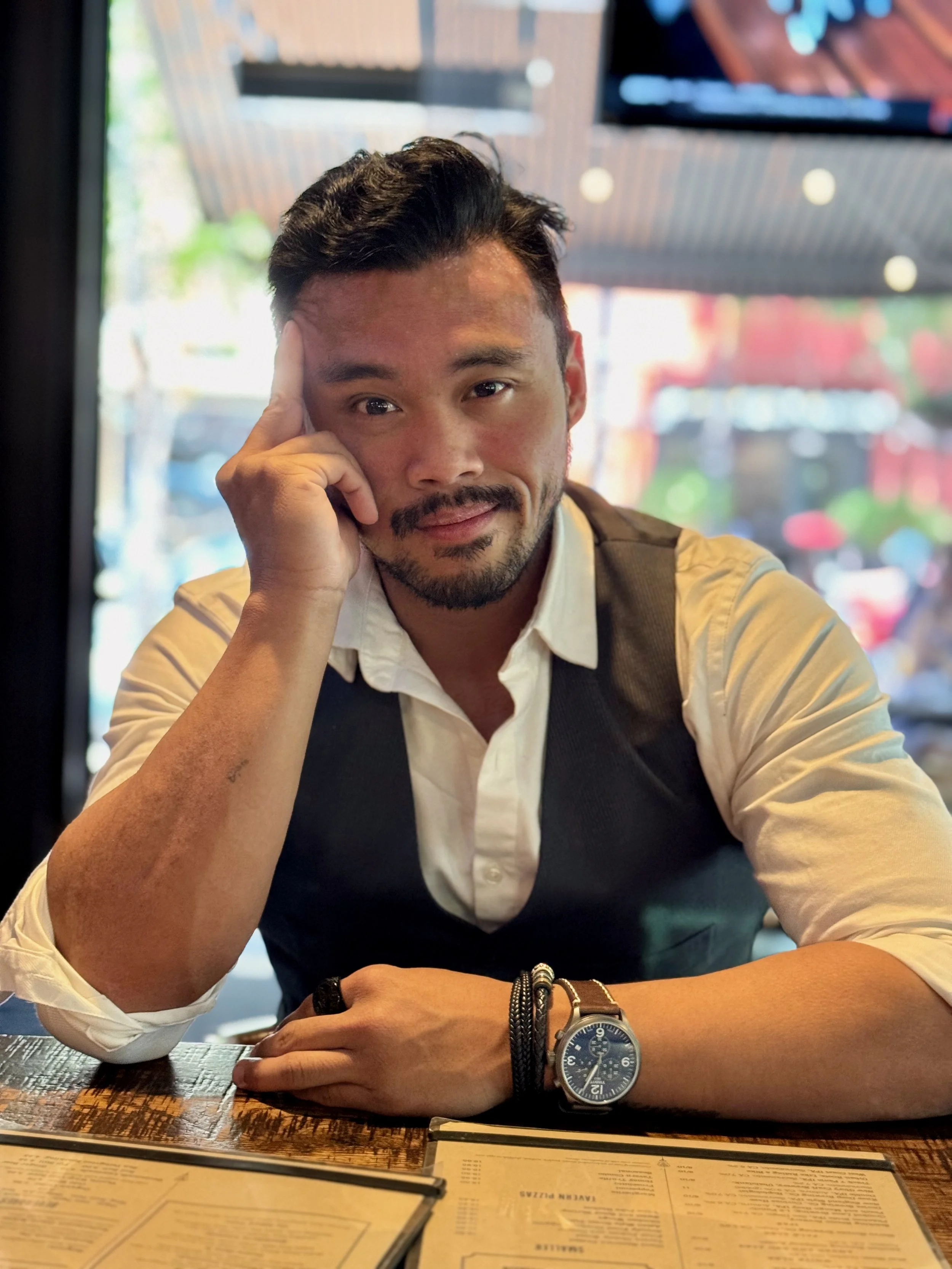 An Expert Finance Expert CFO sitting at a restaurant table. Strategically thinking of business decisions that could lead growth in Medspas, Wellness centers, Clinics, Healthcare