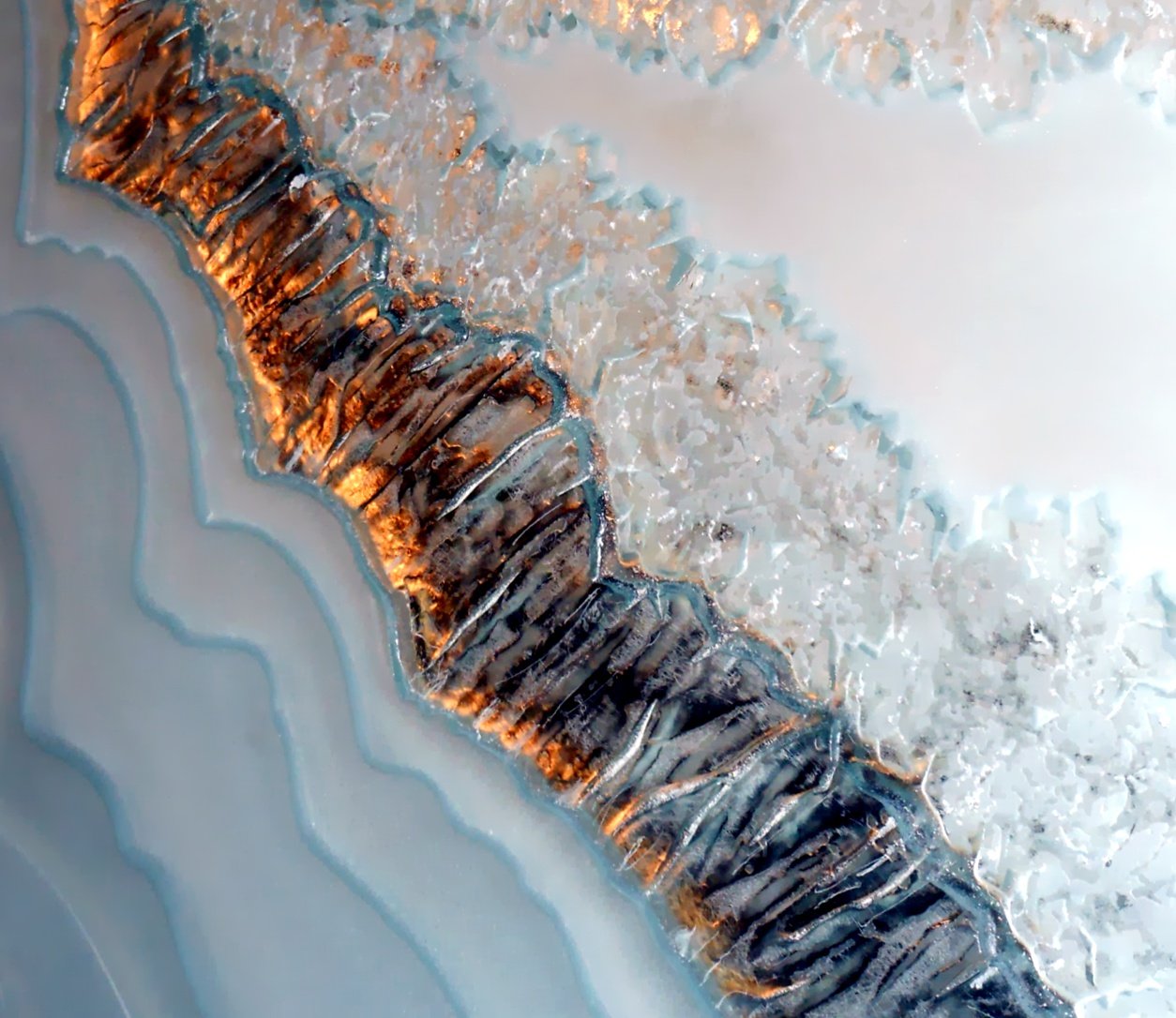 Close-up of a topographical map with a winding river or glacier, featuring detailed contours and icy textures.