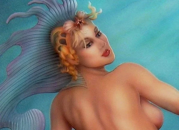A woman with elaborate pastel-colored hair styled in a mohawk and vintage makeup, lying in a pool with blue water.