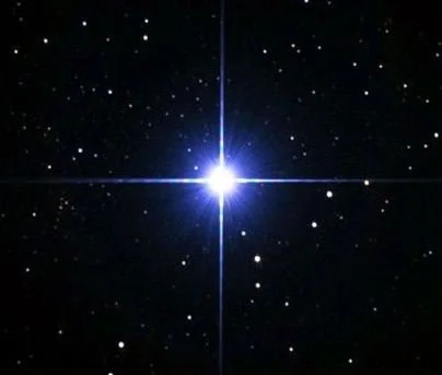 A bright star in space surrounded by smaller stars and cosmic dust.