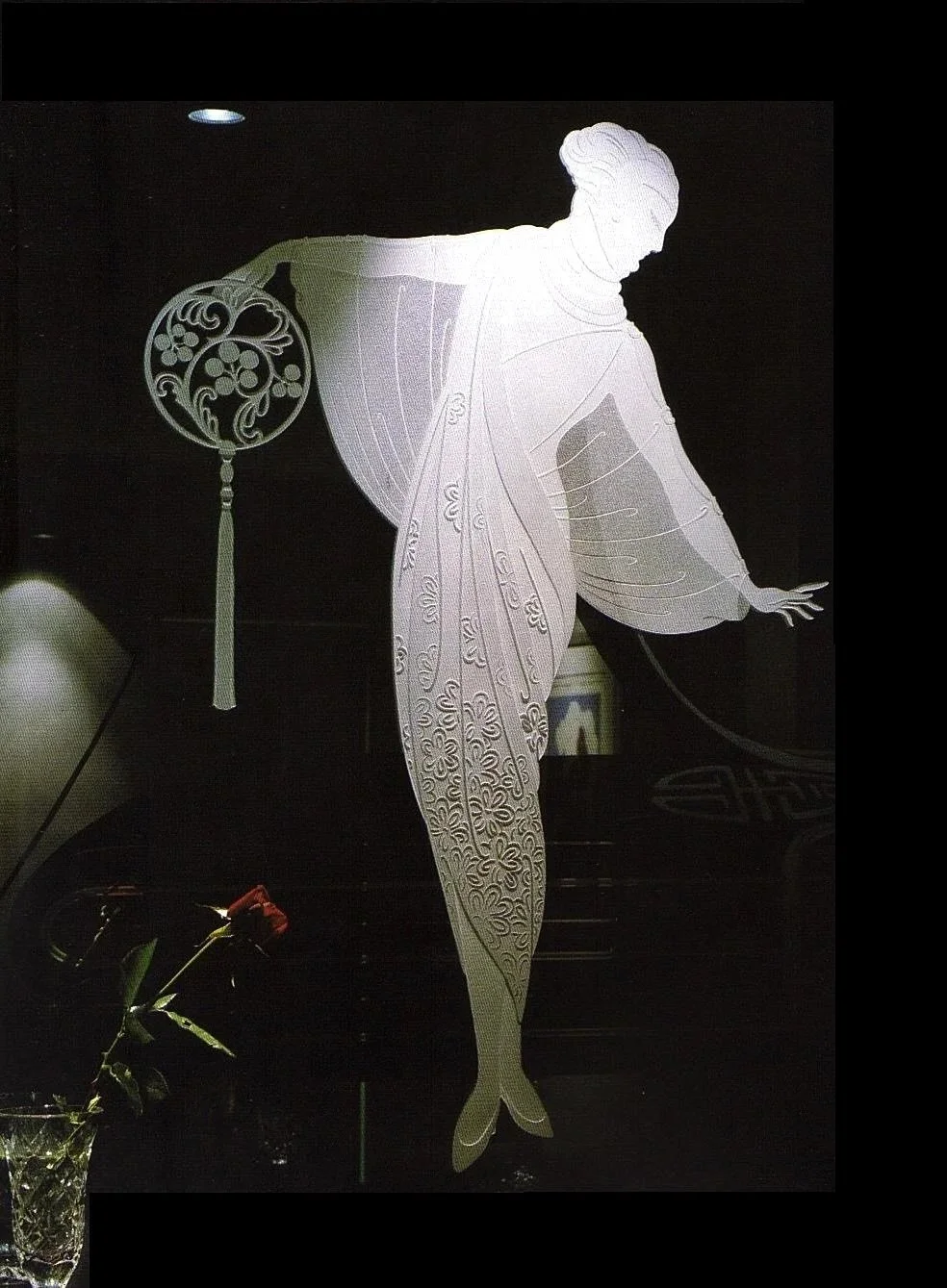 Decorative illuminated black mirror artwork depicting an Erte design, of a woman.