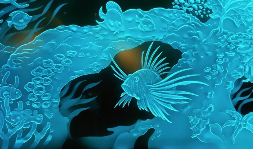 Underwater scene with various glowing fish swimming around coral and rocks in shades of blue.