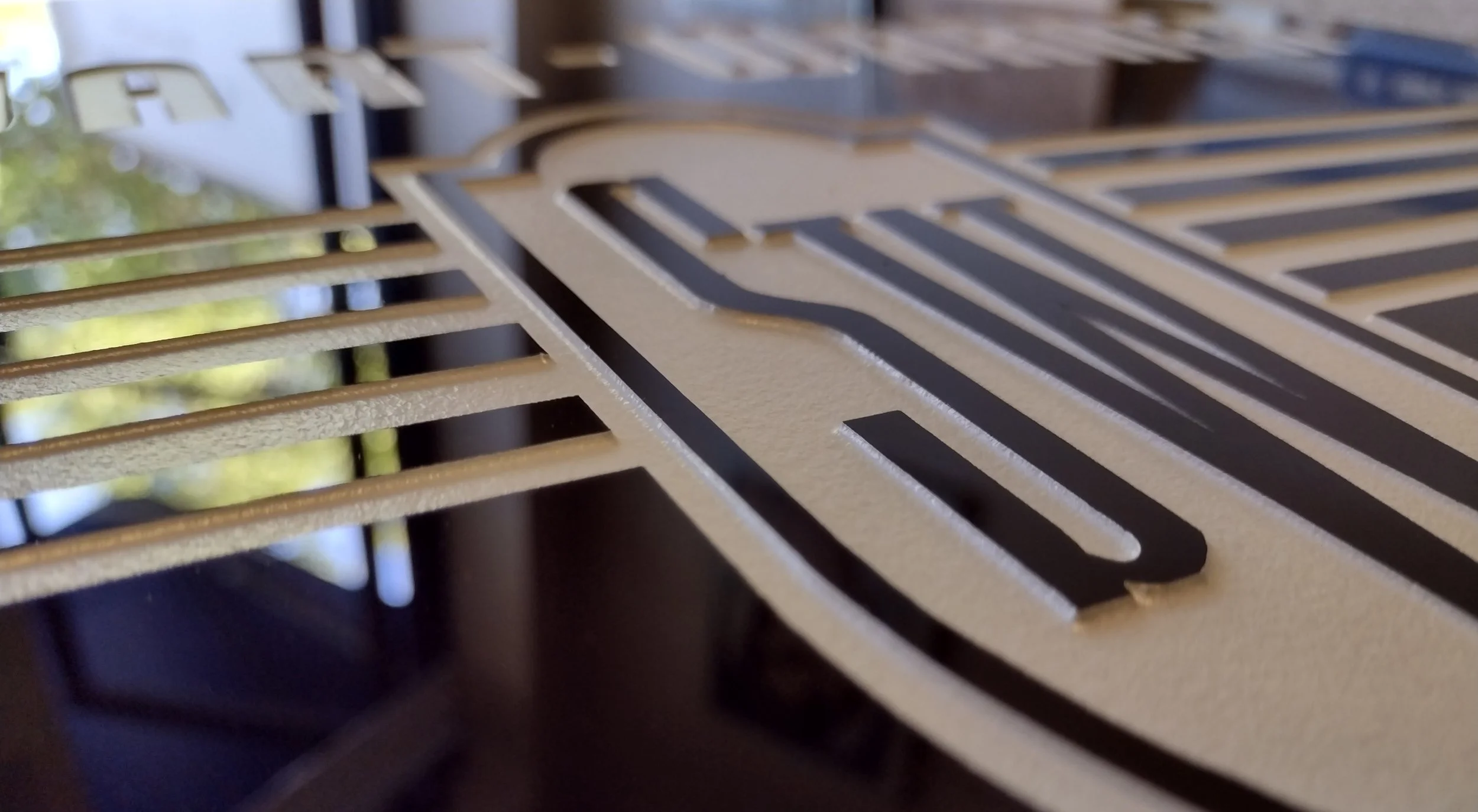 Close-up of a carved glass sign with the letters 'SW", Stewart Warner.