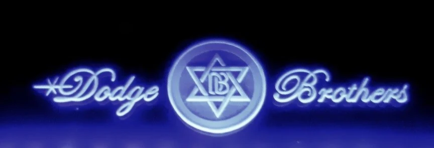 Edge lit glass sign with the words 'Dodge Brothers' and a Star logo in the center.