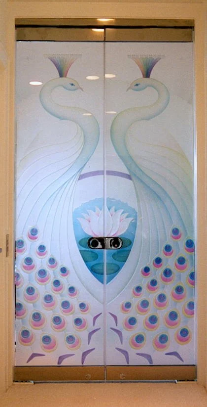 Colorful mural of two peacocks with fan-like tails, facing each other, with a lotus flower and water below.