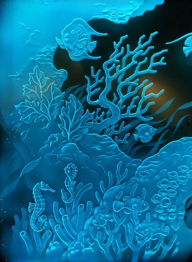 Neon-style illustration of an underwater scene with fish, seahorses, coral, and seaweed.