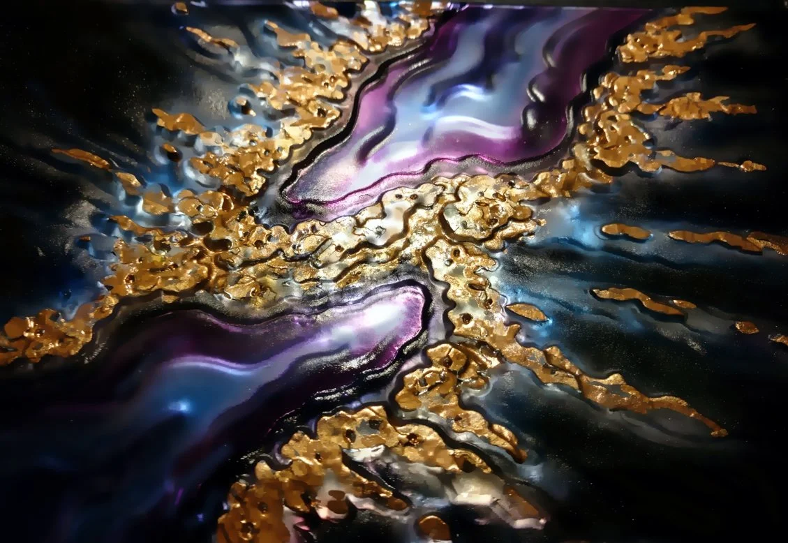 Abstract artwork with swirling purple, blue, black, and white colors accented with gold foil details.