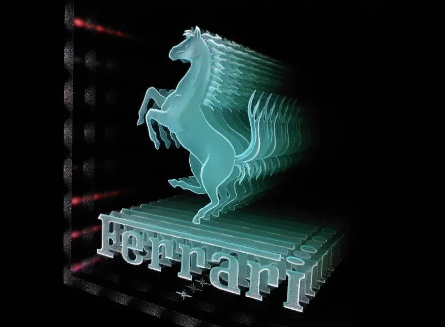 An infinity carved glass, 3D sign of a blue prancing horse above the word 'Ferrari' logo, set against a black background.