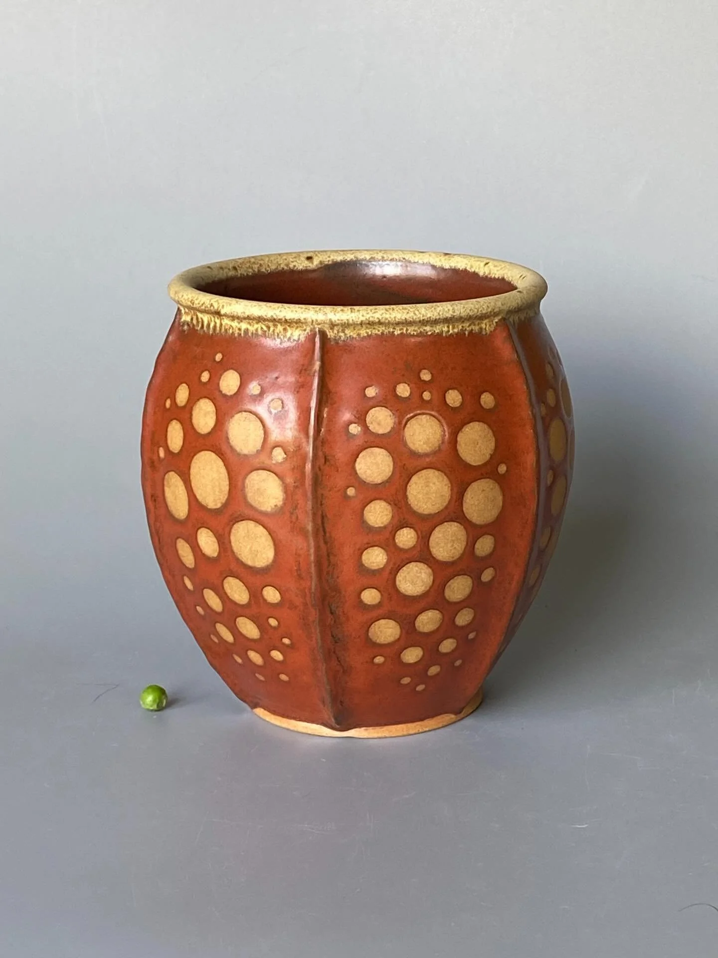 This is the third and largest of three ribbed, pod-like pots I made recently.  It&rsquo;s glazed in rust red with a cream rim and burnished circles.  But what is it? 

Deciding on a descriptor for things I make is tricky.  I&rsquo;m not sure if other