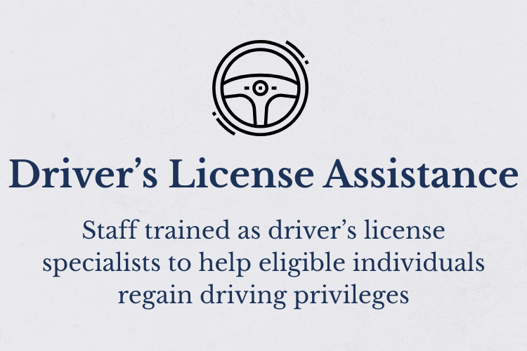 Sign with a steering wheel icon reading 'Driver's License Assistance' and smaller text explaining staff are trained as driver’s license specialists to help eligible individuals regain driving privileges.