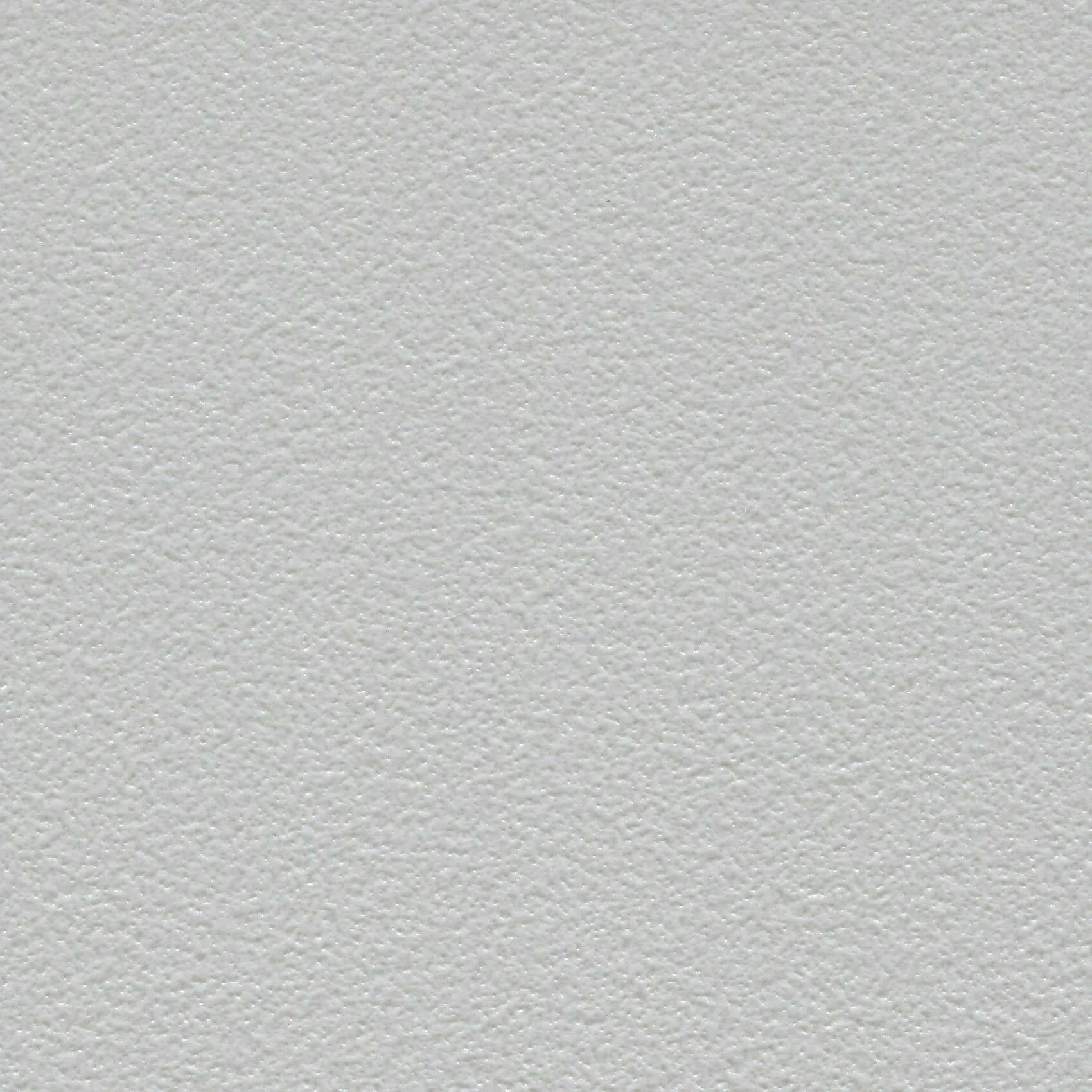 Close-up of a textured white wall with a slightly rough surface.