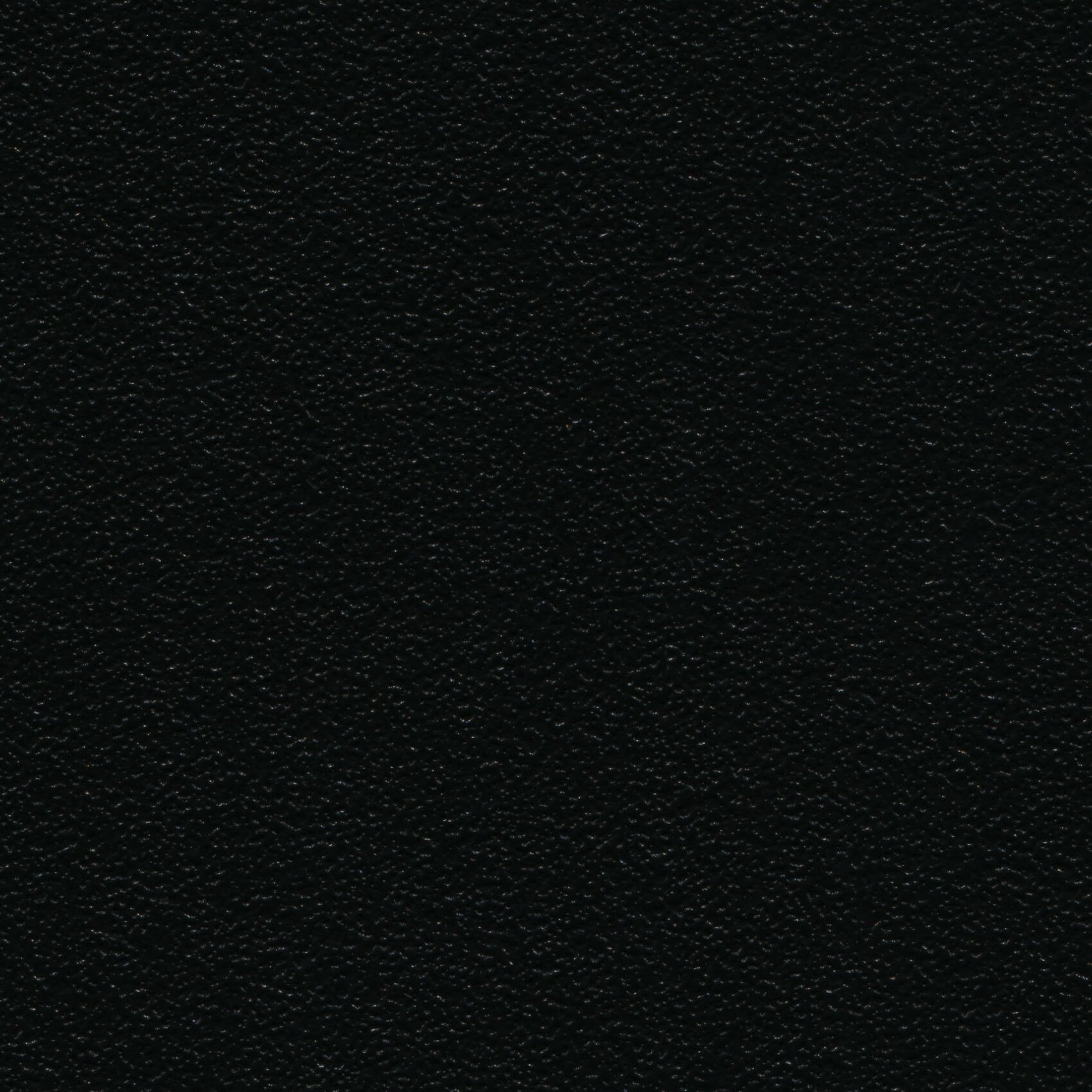 Close-up of a black, textured surface, possibly leather or synthetic material.