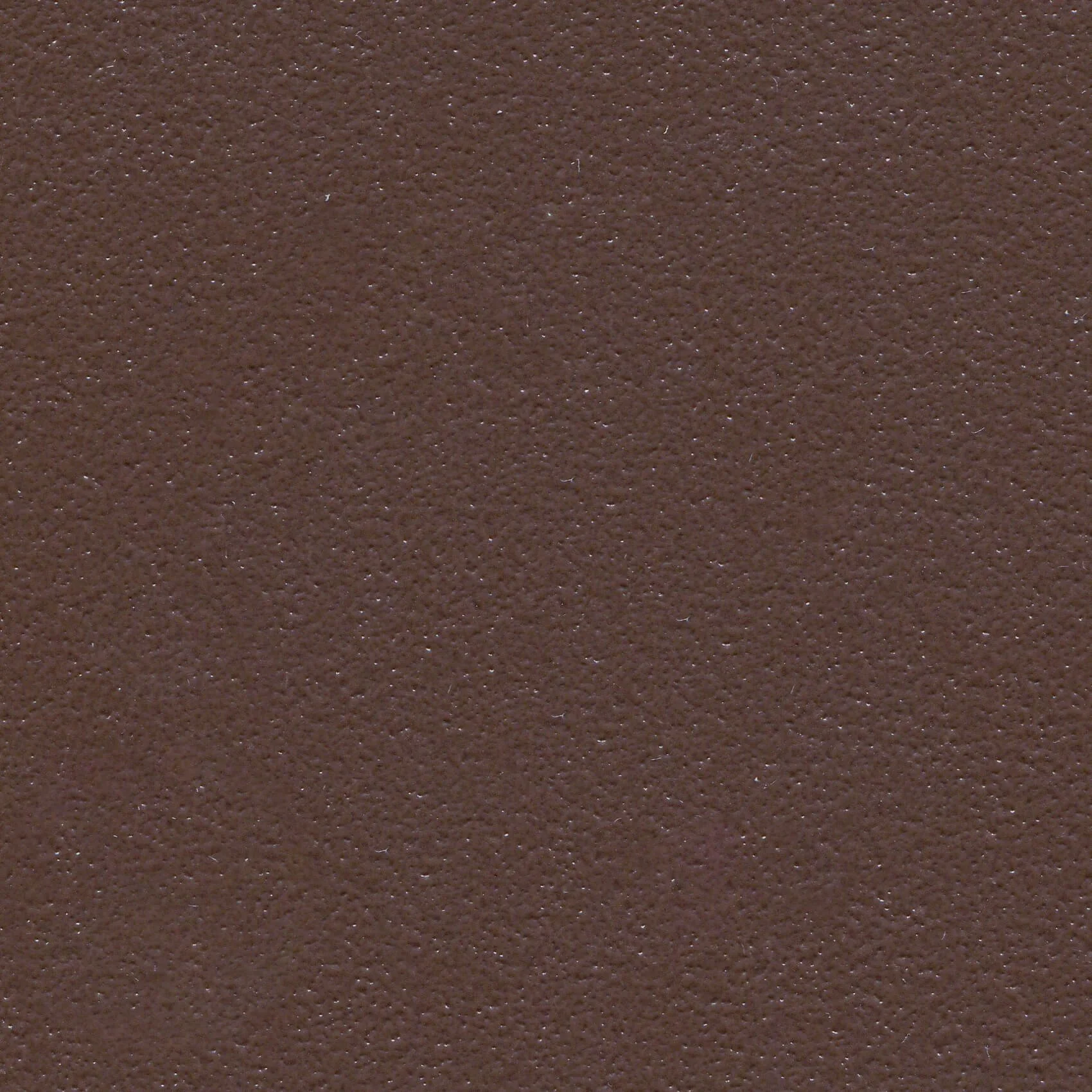 Close-up of a brown, textured surface, possibly leather or synthetic material.