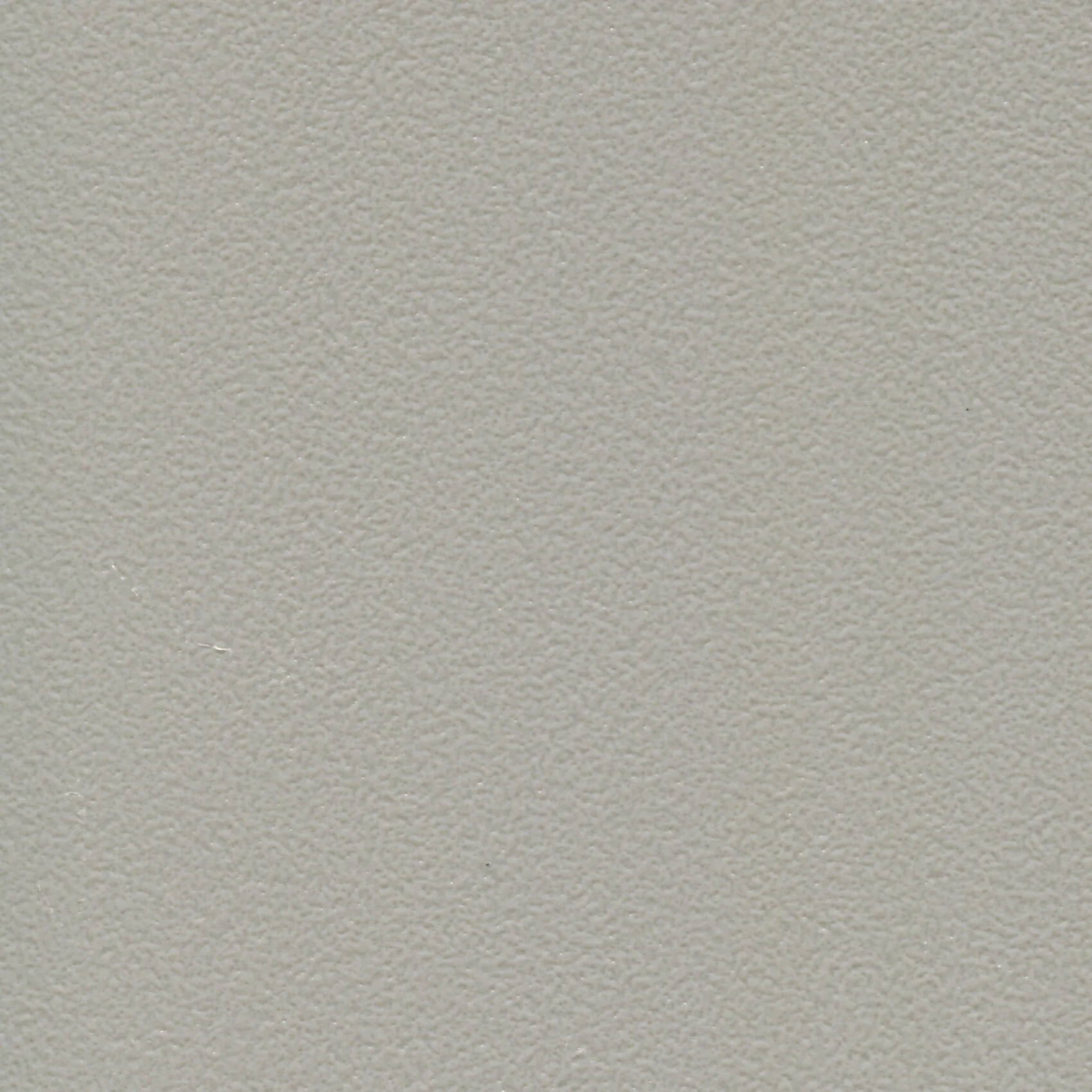 Close-up of a textured beige surface, possibly a wall or ceiling
