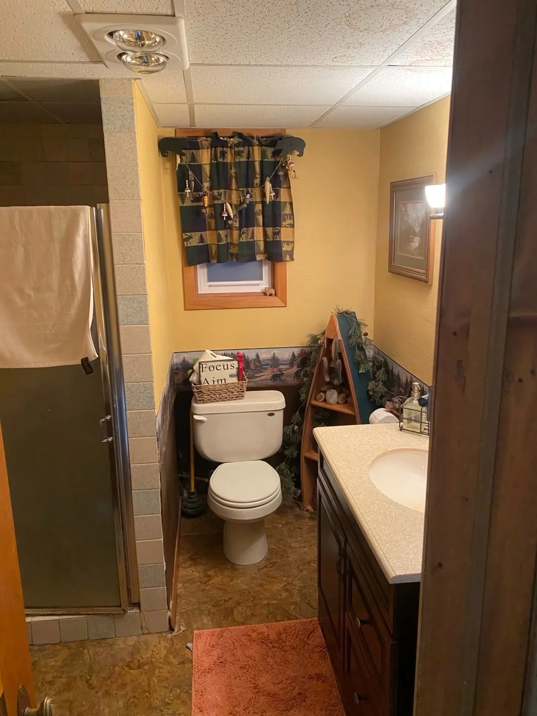 Bathroom before the update, showing the earlier vanity and patterned wall finish