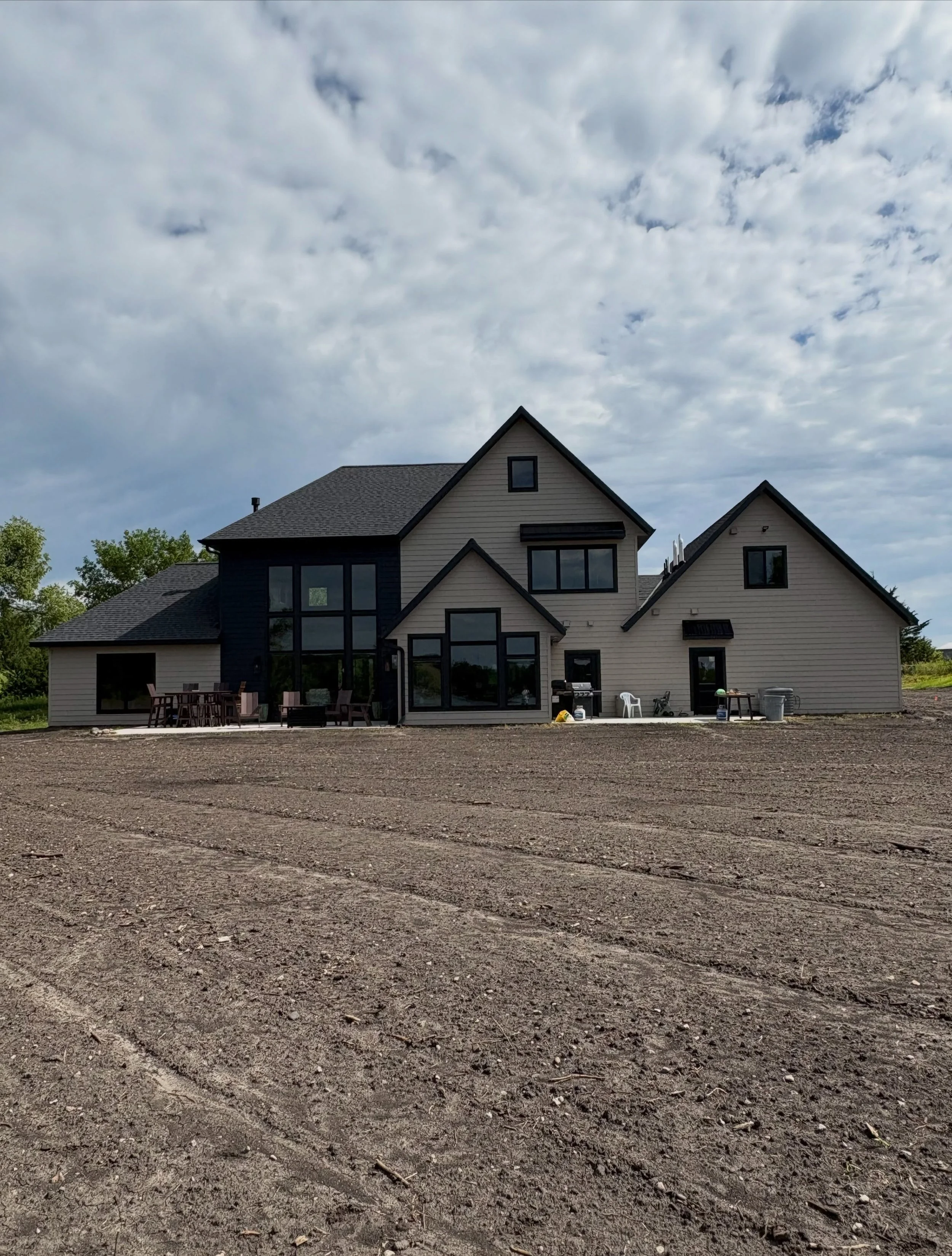 Rear exterior of the custom home, showing the rooflines and back entry