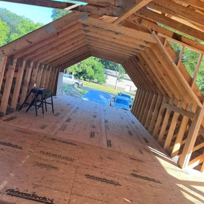 Interior roof and wall framing with an open end during home construction.