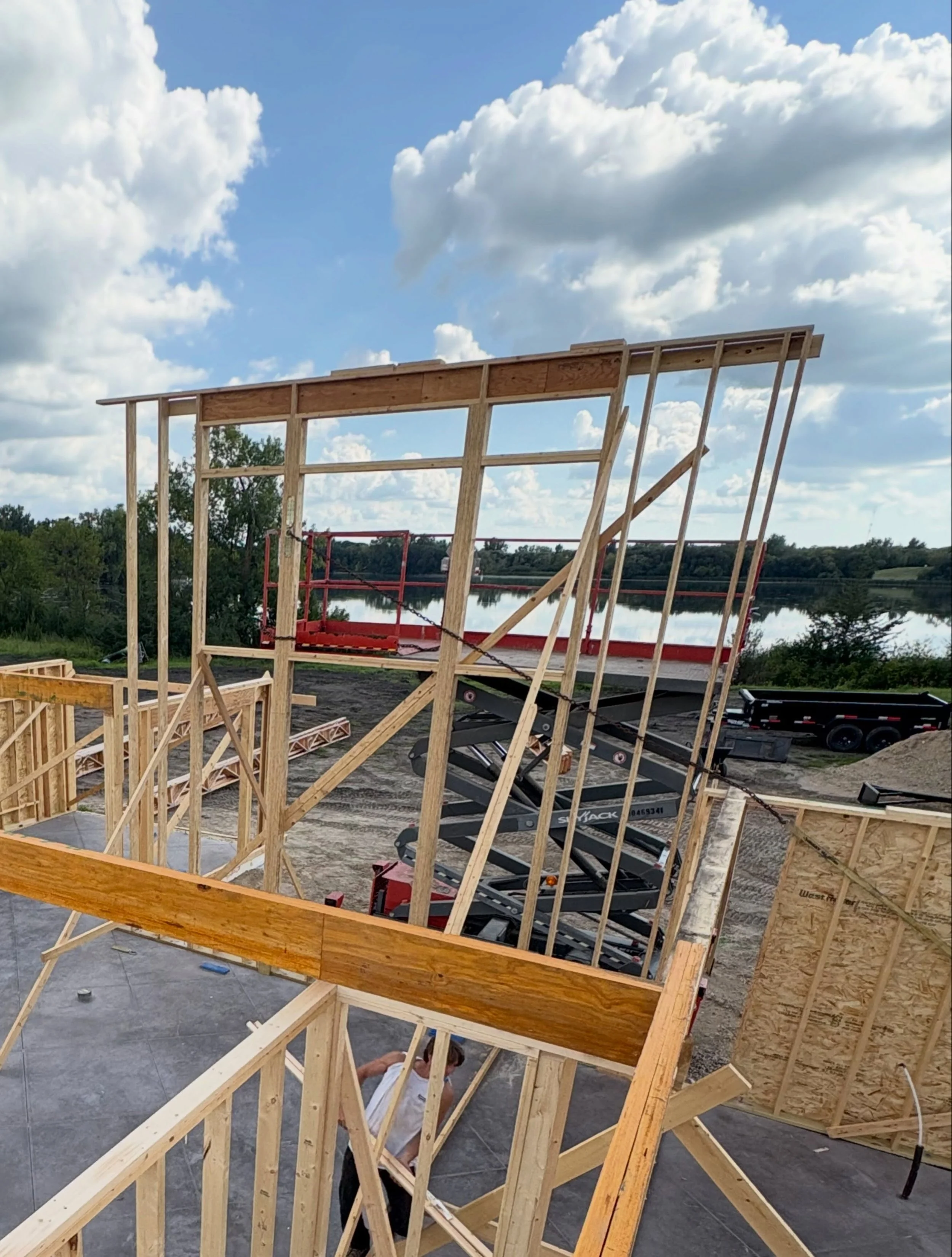 Custom-home roof framing in progress before exterior finishing