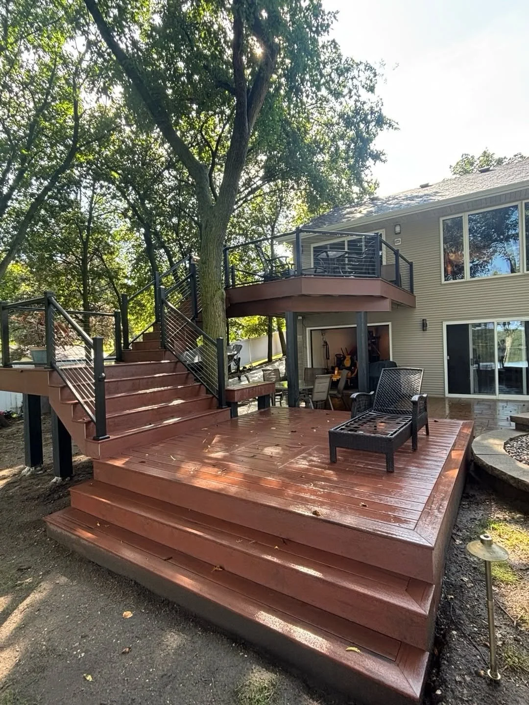Completed New London deck beside the home, with stairs and railings