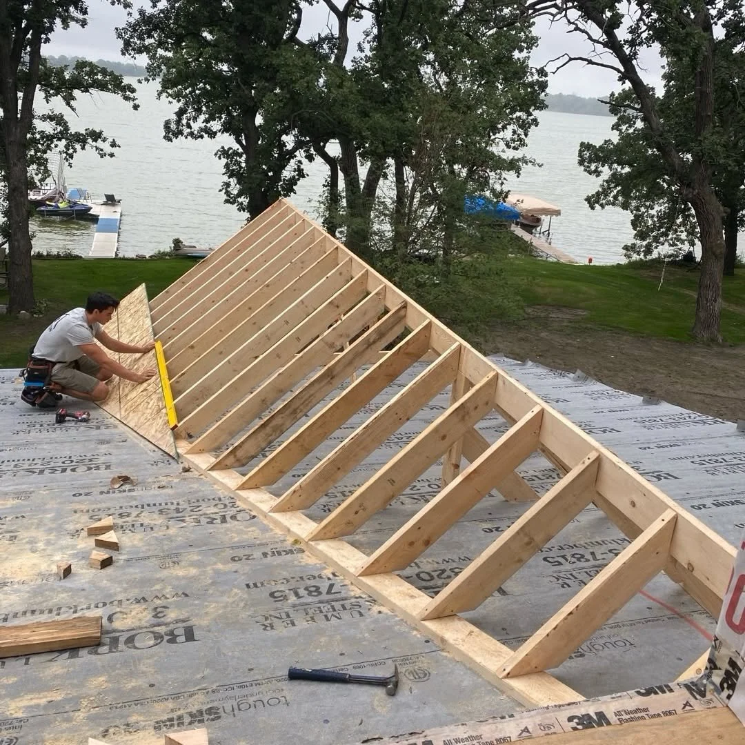 Triangular framing assembled on the floor deck during home construction.