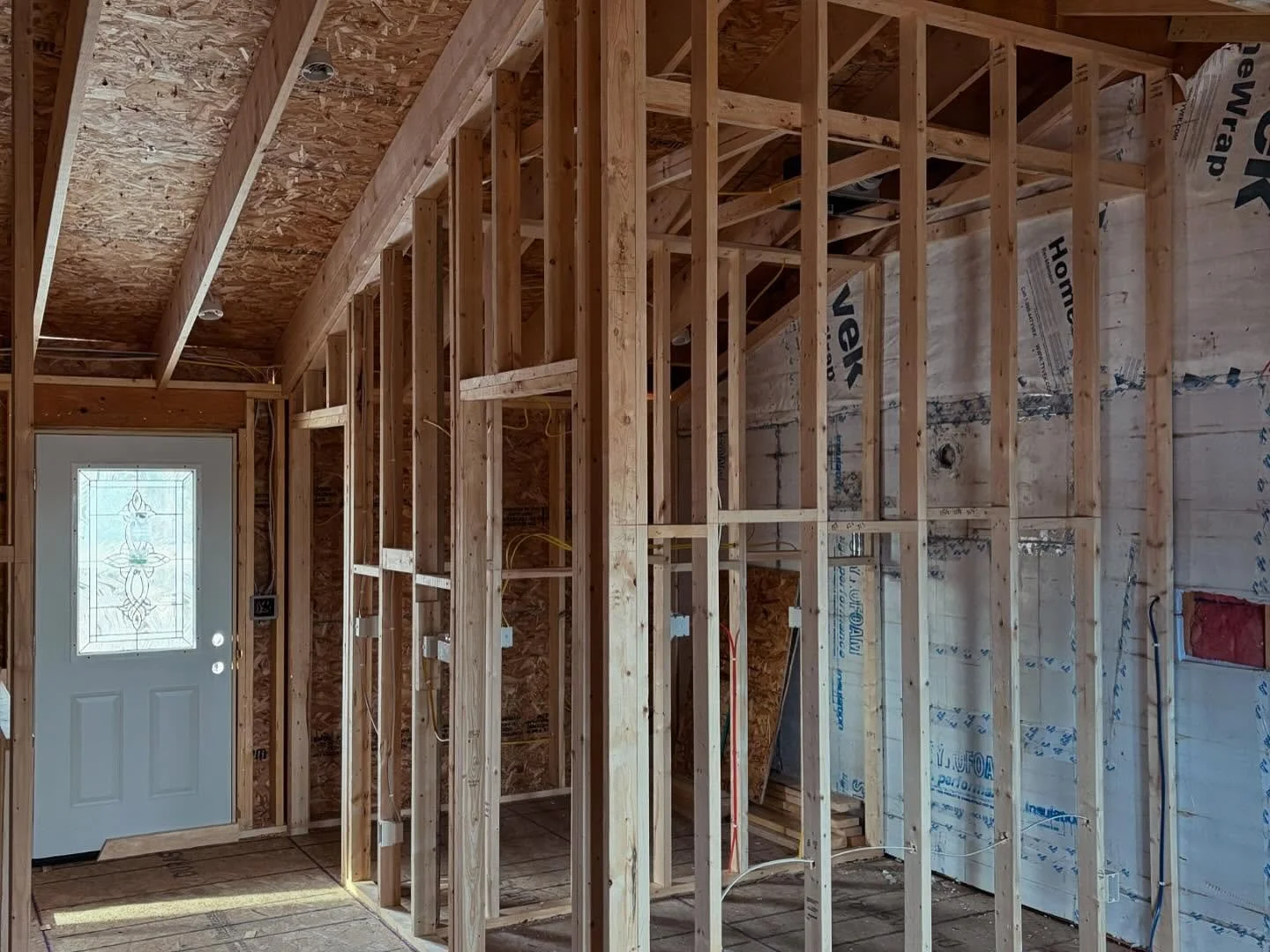 Interior wall and floor framing inside the two-story addition during construction