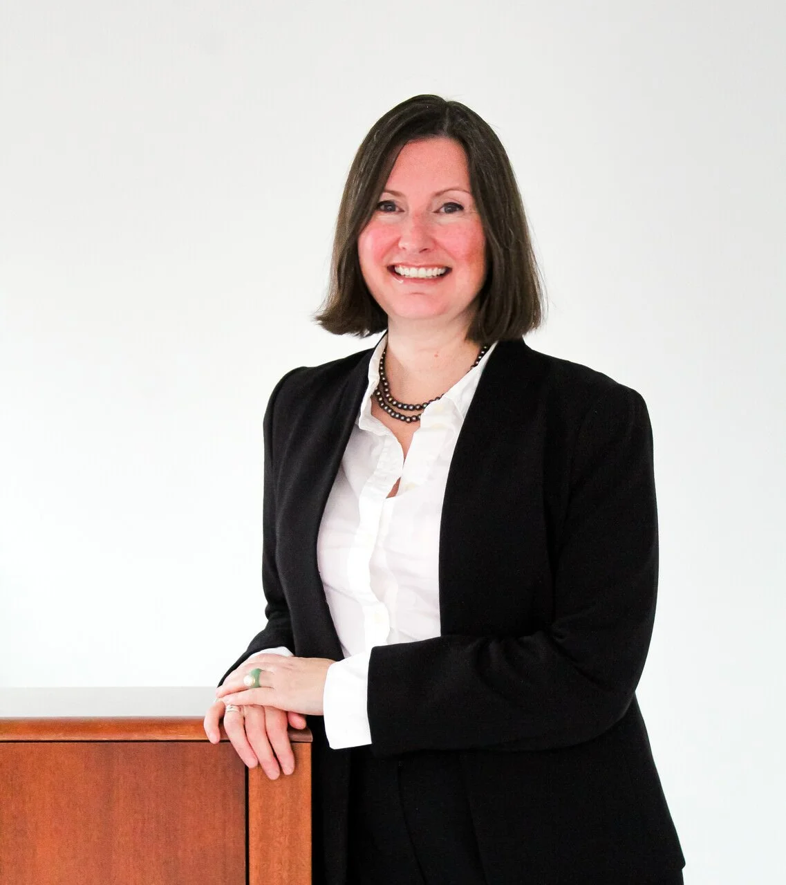 Megan B. Quirk, Partner at Quirk Law, smiles at the camera in her headshot.
