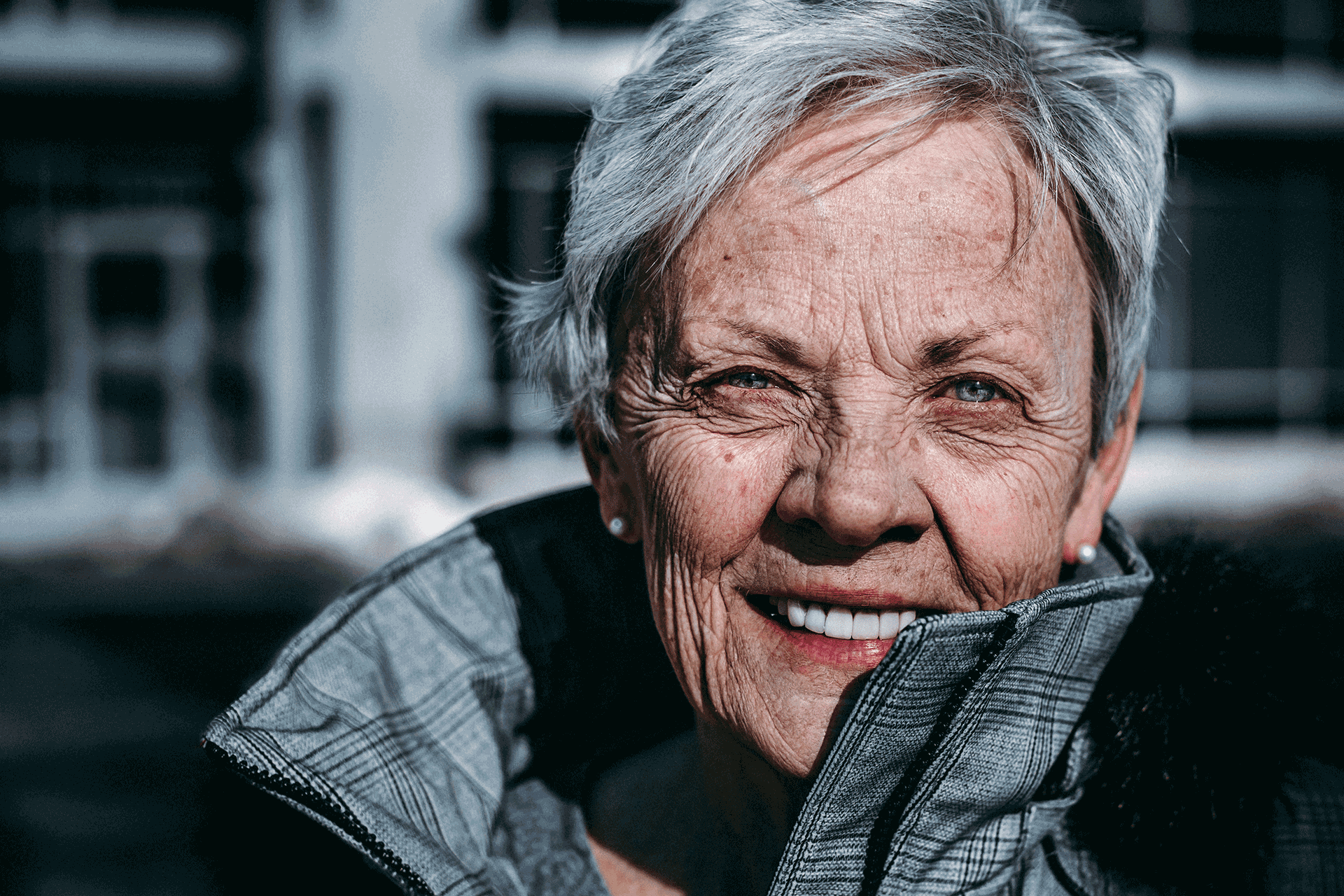 older woman smiling, happy that her pension security is taken care of