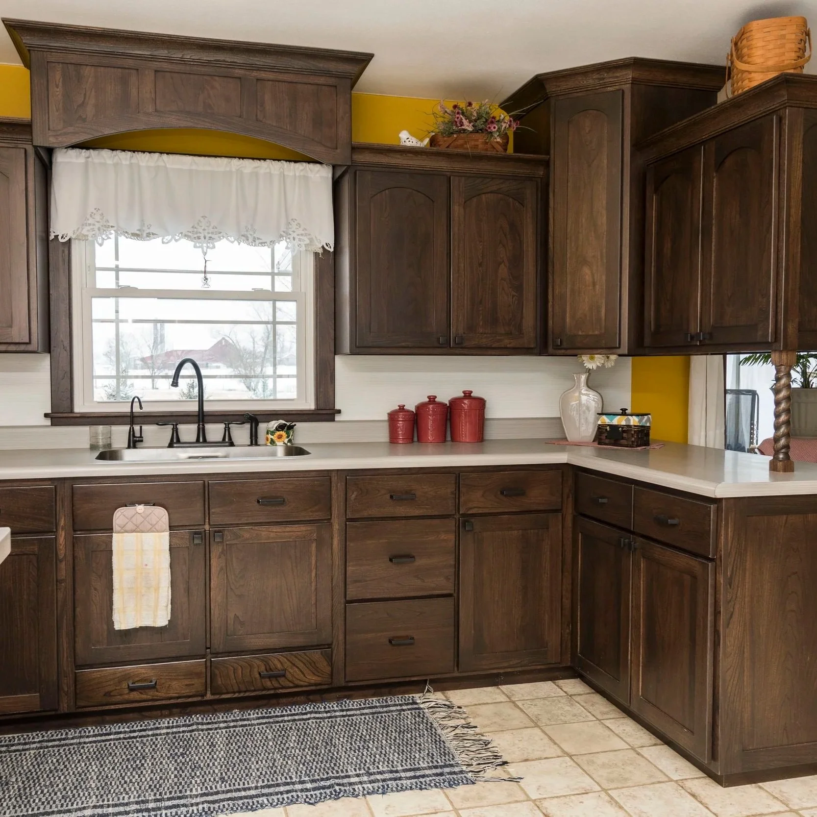 Dark Wood Kitchen with Arched Valance & Staggered Wall Cabinets