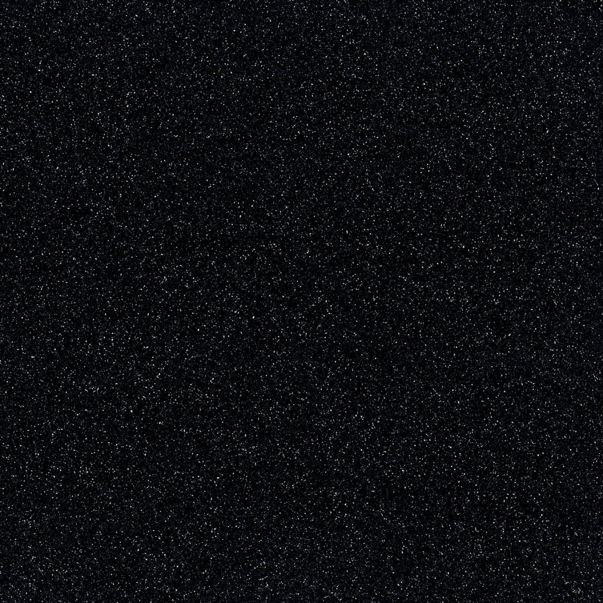 Close-up countertop swatch with white specs scattered across a dark background.