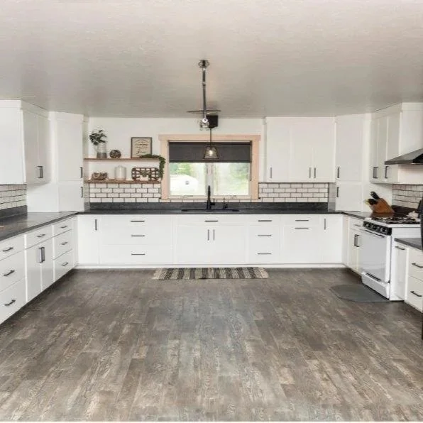 White U-Shaped Kitchen with Split-Level Countertop & Floating Shelves