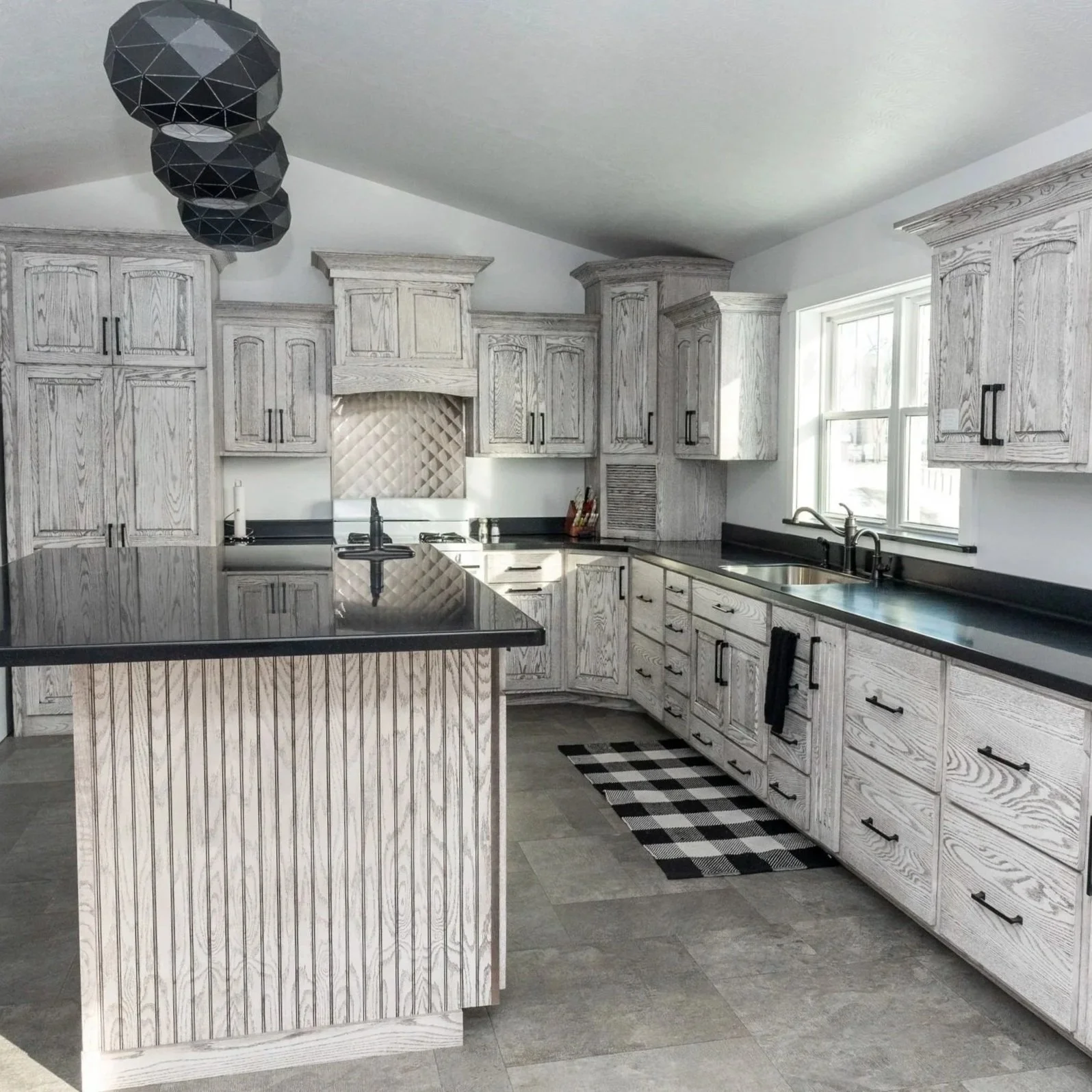 Cerused Wood Cabinets with Reeded Island & Custom Range Hood