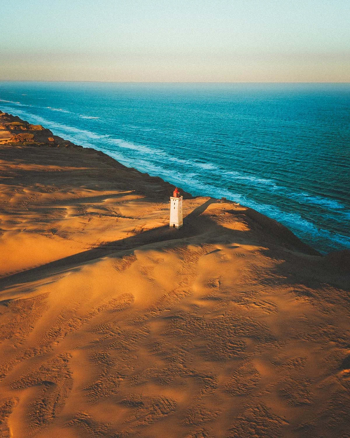 Le célèbre phare de Rubjerg Knude, partiellement enseveli par les dunes de sable mouvantes sur la côte de la mer du Nord au Danemark.