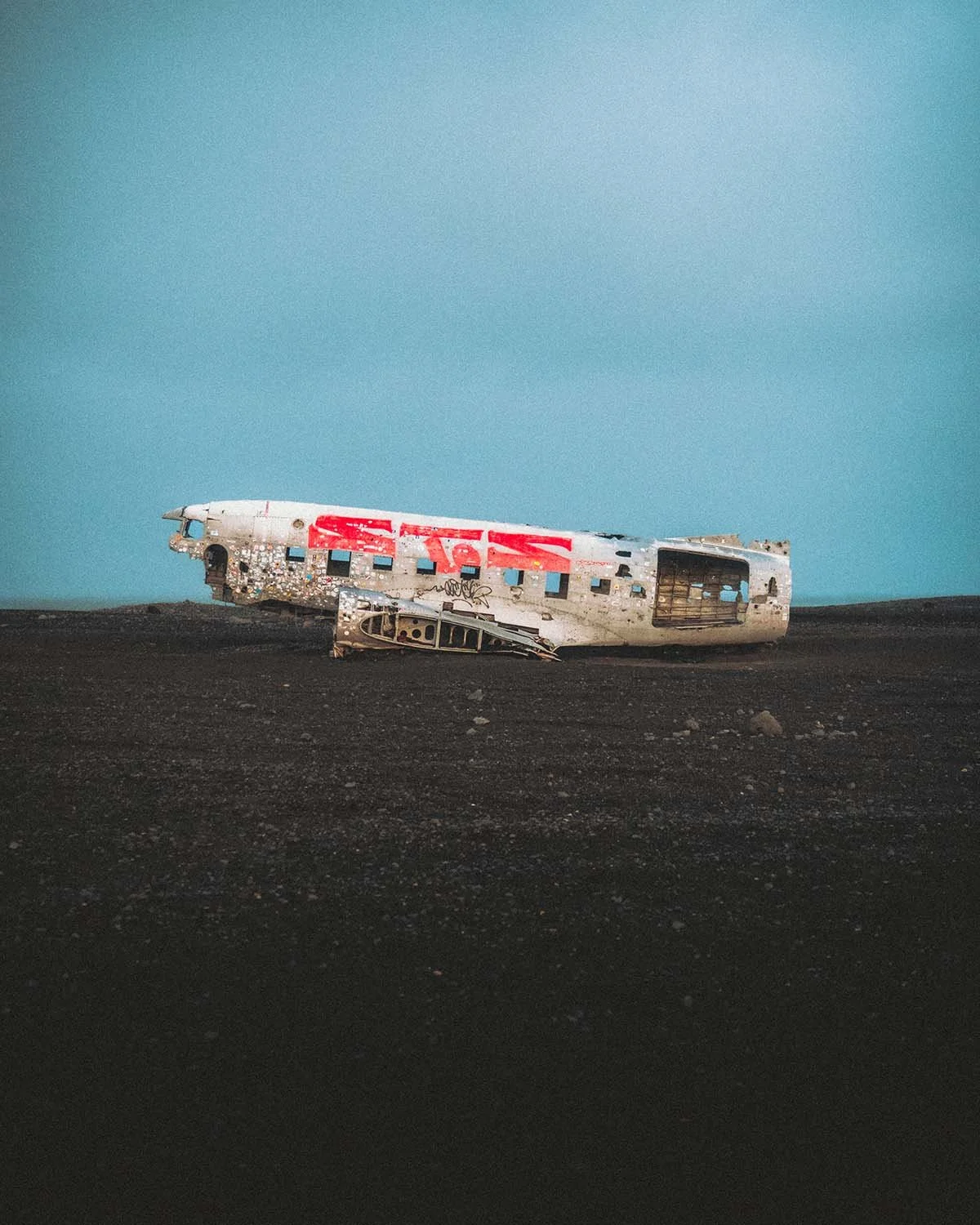 La célèbre carcasse de l'avion DC-3 de l'US Navy abandonnée sur la plage de sable noir de Sólheimasandur. Lieu de photographie iconique en Islande.