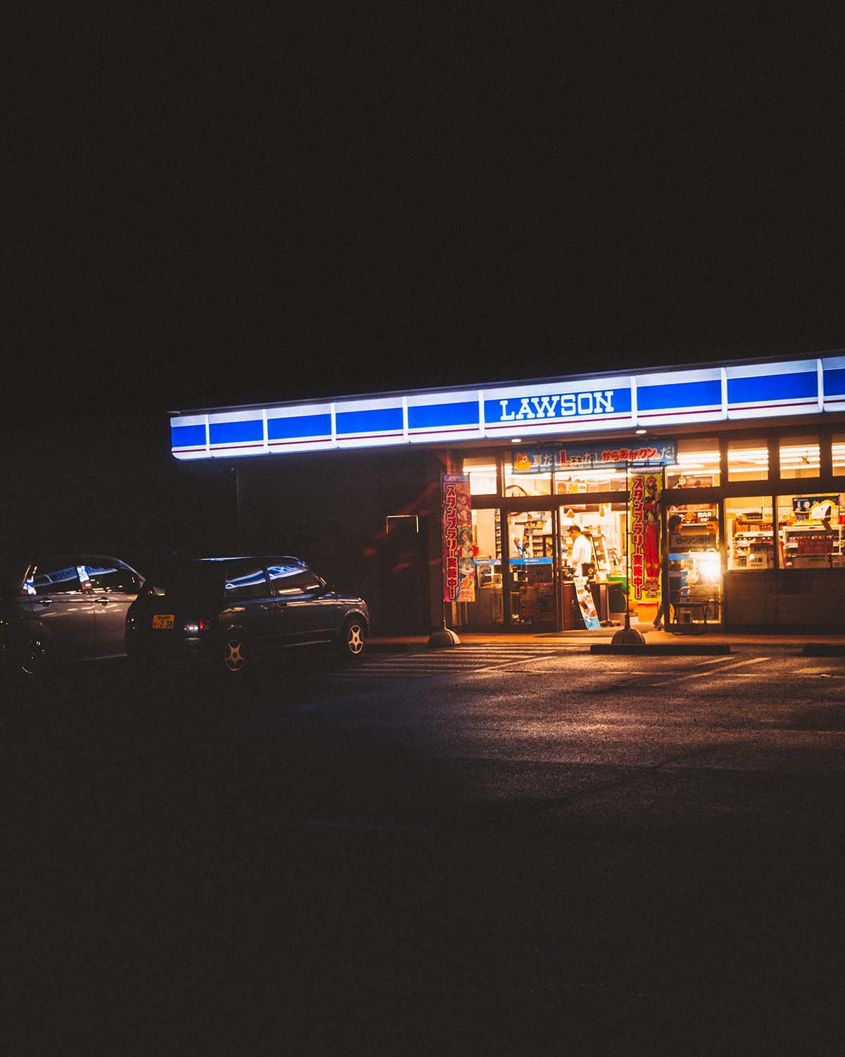 Escale nocturne. La lumière familière d'un konbini au bord de la route.