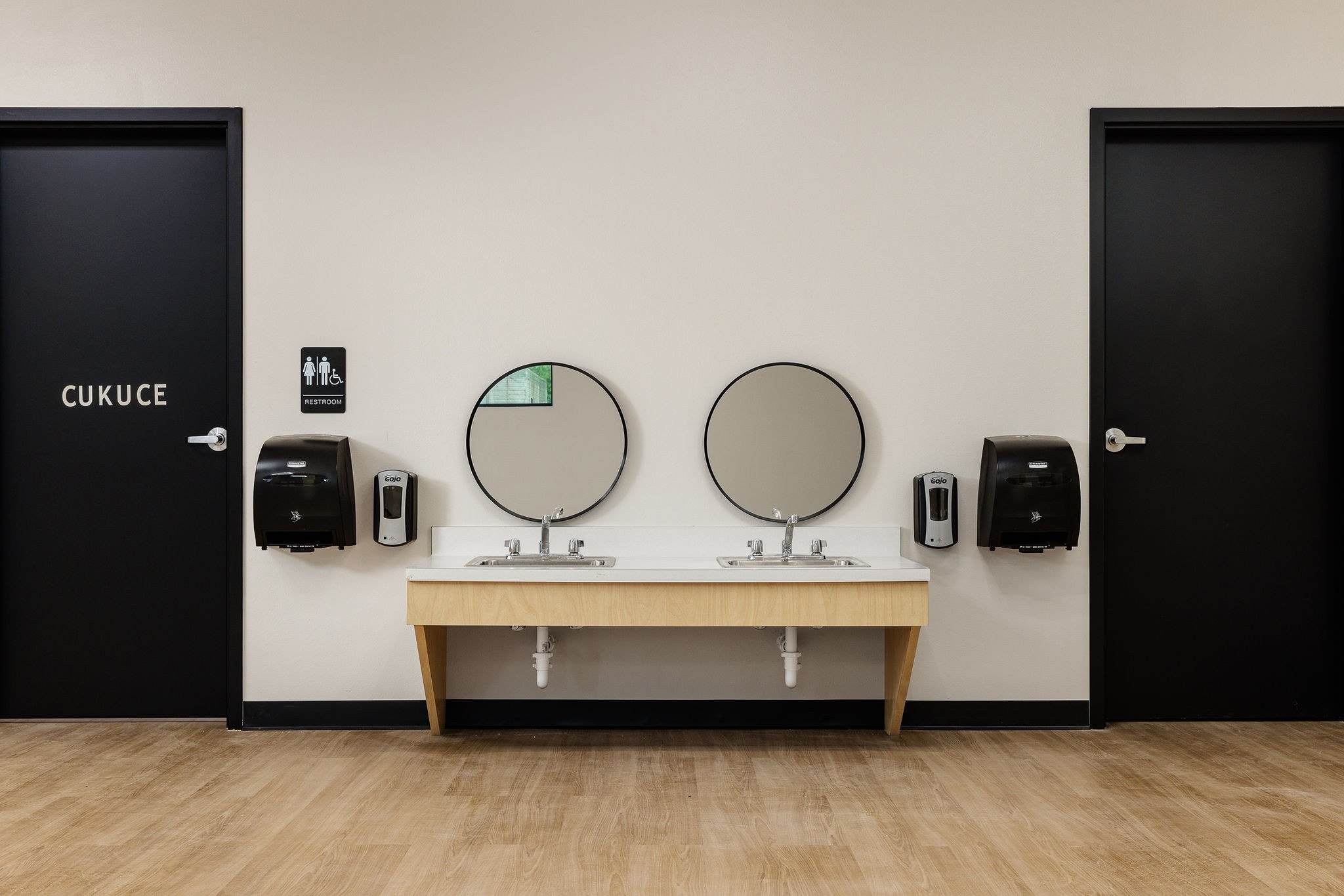Child-height hand-washing station and restrooms with Mvskoke signage at Barking Waters Head Start in Wewoka, Oklahoma