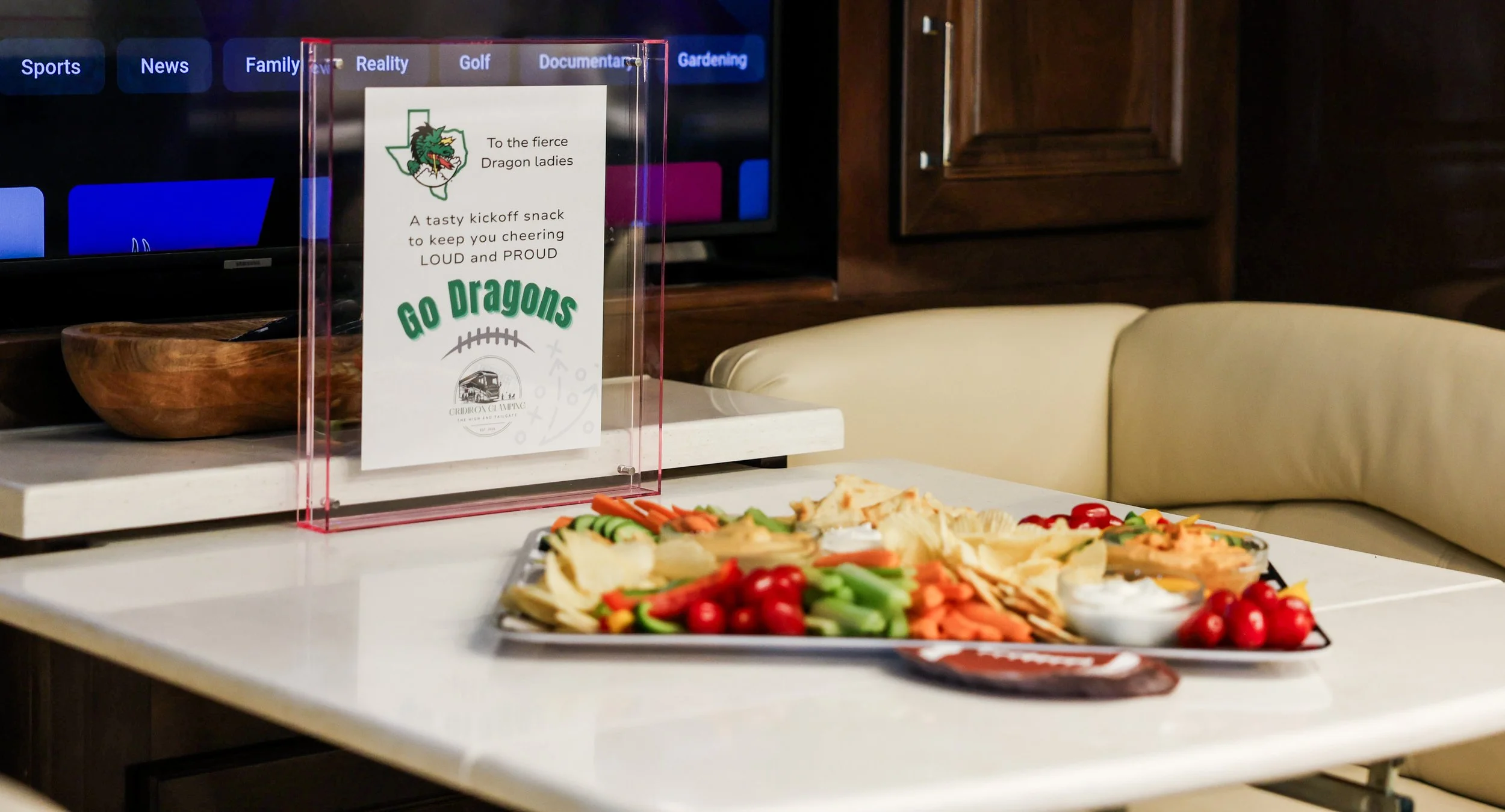 A tray of assorted vegetables and dip on a white table in a restaurant setting.