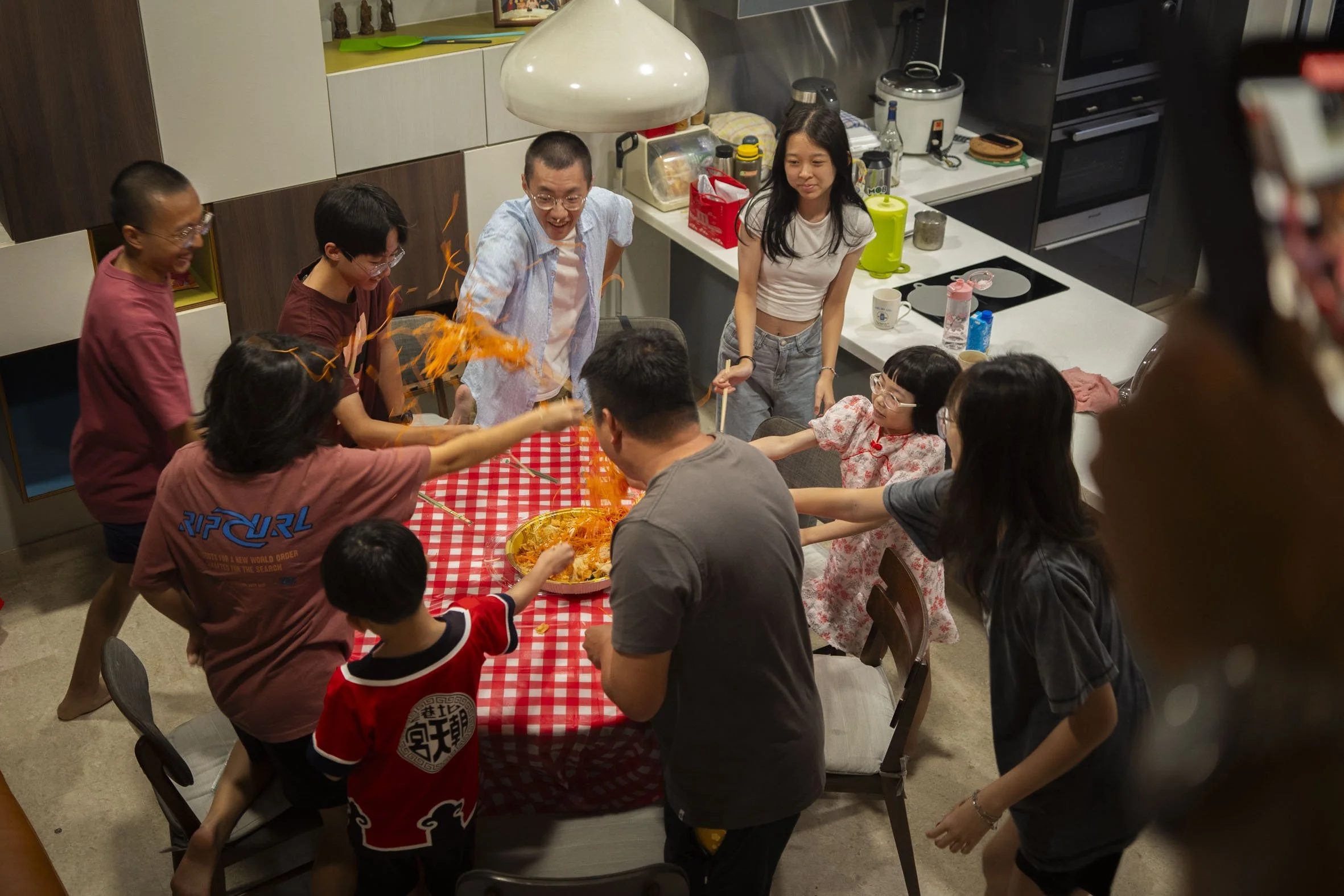 "3…2…1…Huat ah!”  Shreds of carrots and Yu Sheng ingredients fly as the younger ones toss a plate of Yu Sheng the adults prepared while waiting to “send off” Ti Gong later.  The adults took videos of the boisterous scene and laughed on the sidelines.