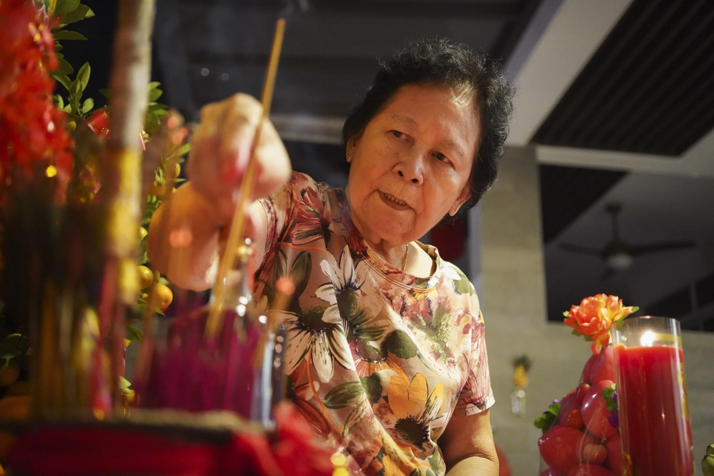 After dinner, the altar is set up and Mdm Lim offered the first three joss-sticks once the ritual began.  Family members and guests take turns lighting incense leading up to midnight when another ceremony will take place.  “I just pray for my family’