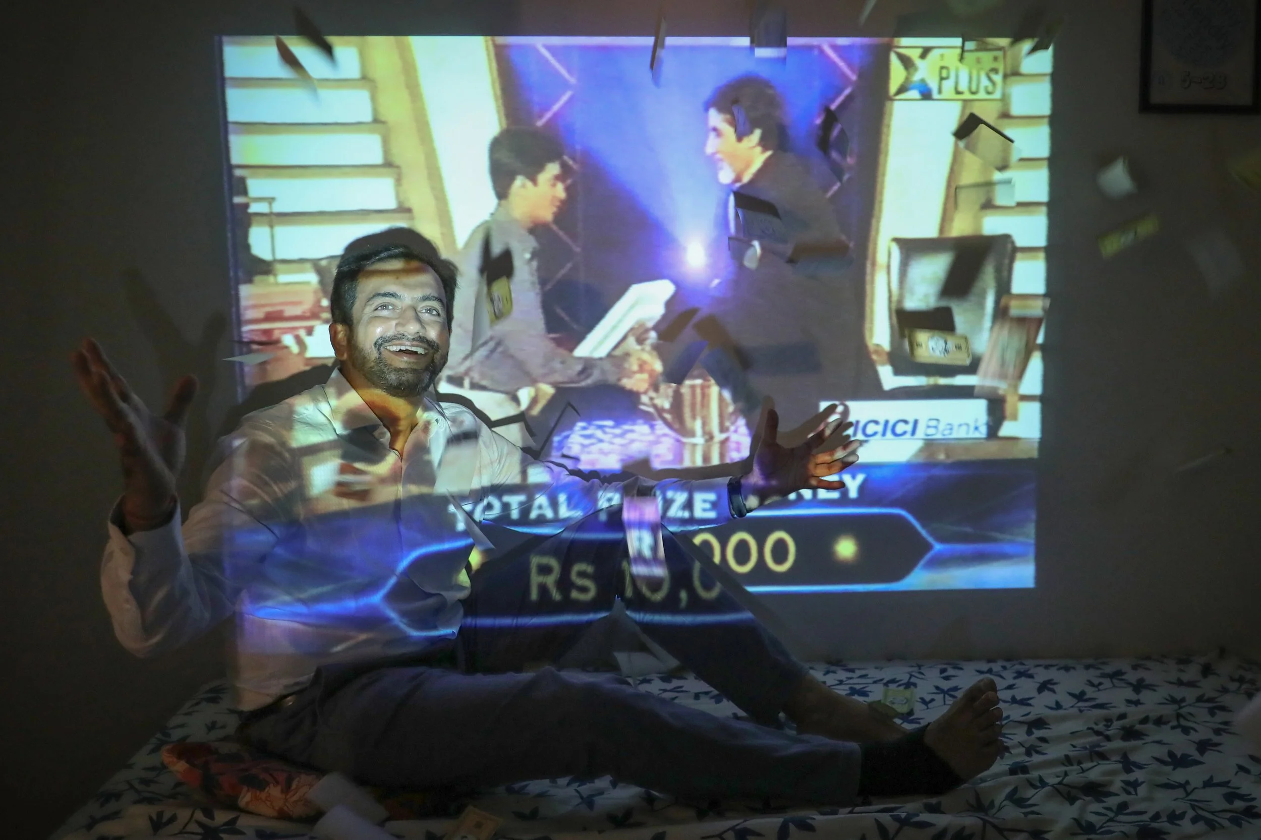 Mr Sandeep Pawaskar with a screen showing a 2001 VHS recording of him taking part in the Indian version of popular game show Who Wants To Be A Millionaire, hosted by Bollywood megastar Amitabh Bachchan.


