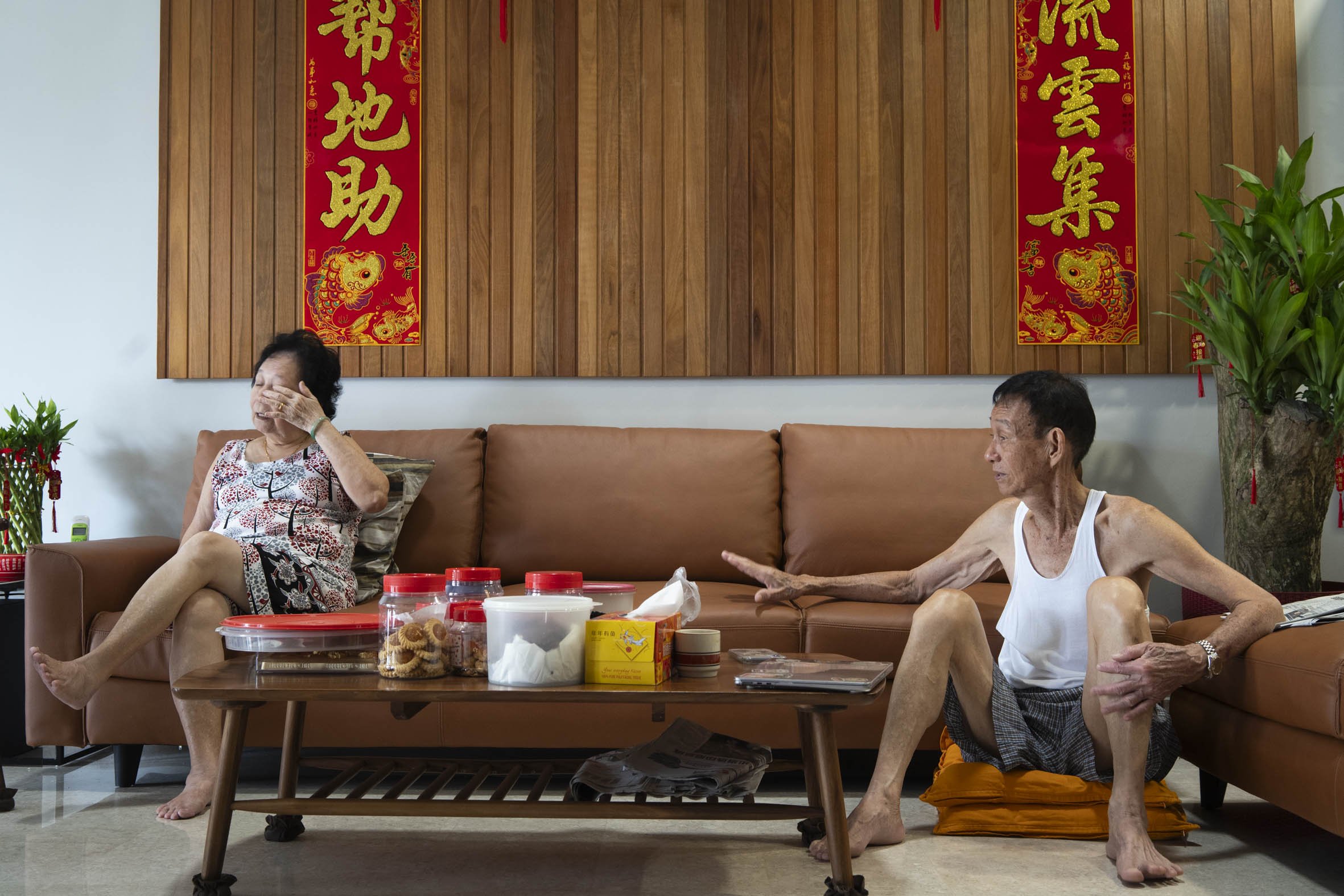 The day before, Mdm Lim still had free time and watched television with her husband, Mr Ng Tian Seh (right), 85.   She learnt to perform the Taoist rituals from his family and remains committed to the practice today.   Mr Ng was sharing the folktale 