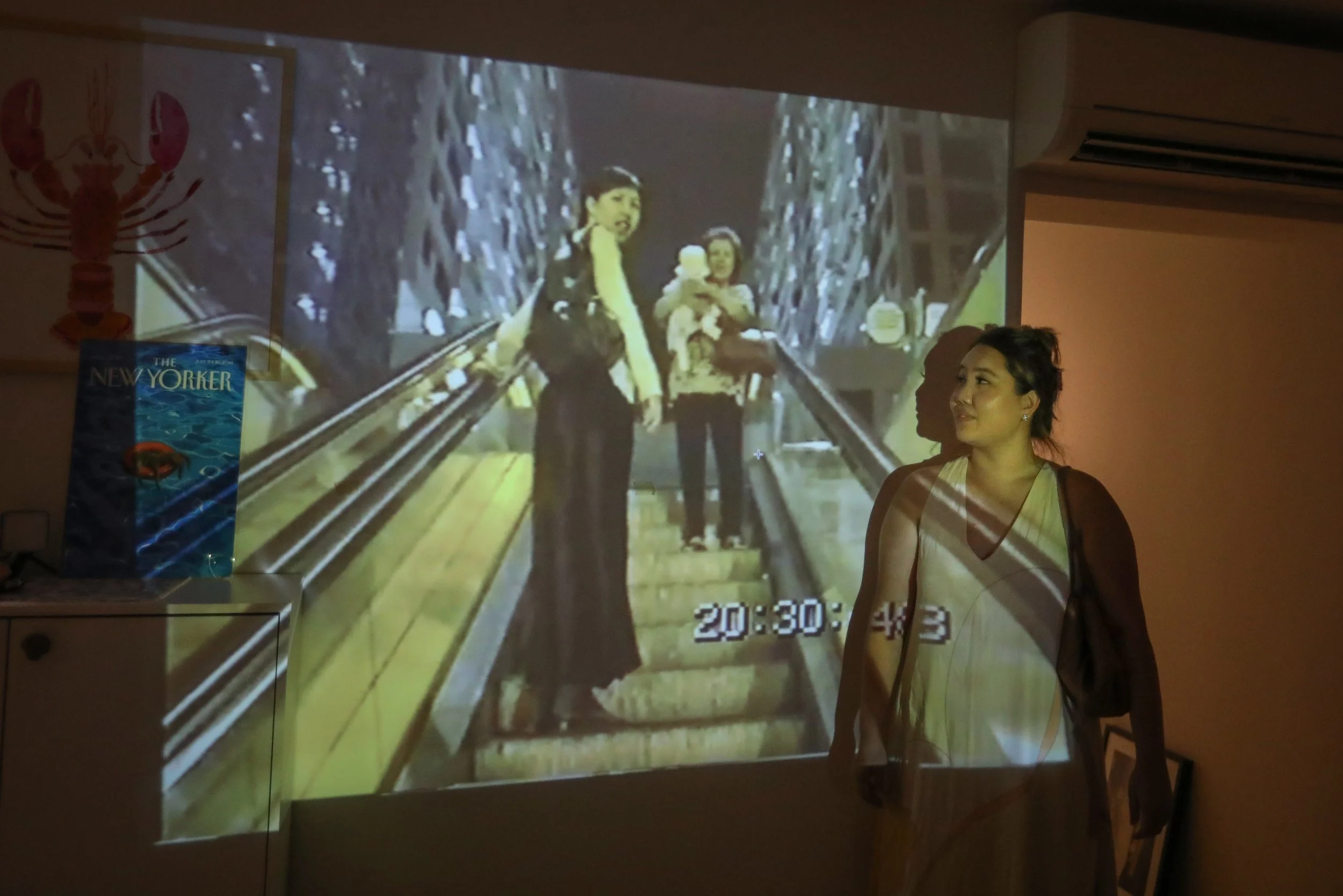 Ms Tanya Tan looking at her one-year-old self being carried by her maternal grandmother as her mother looks at the camera, in a 1998 recording her father captured at Hong Lim Complex after a family dinner.