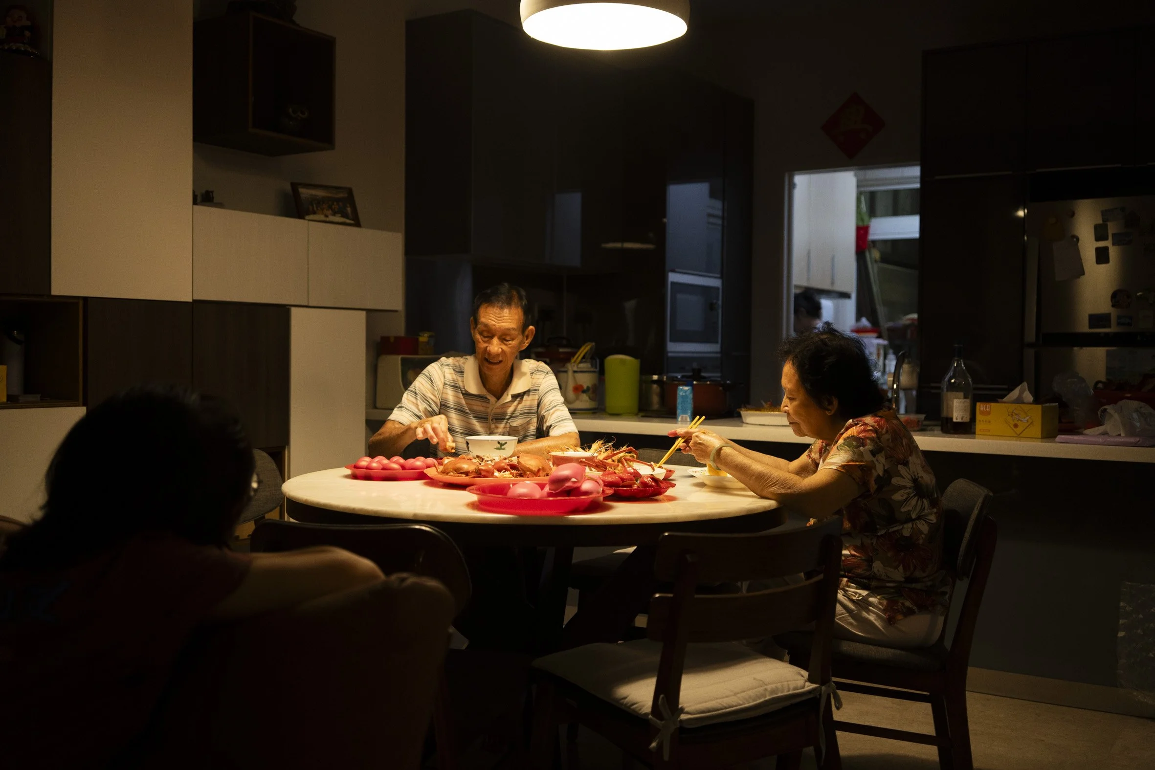 At last, the last guests had their fills and left. It was 4AM. After packing the offerings and cleaning up, Mdm Lim could finally sit down.   
Only Mr Ng and Mdm Lim had yet to eat. The porridge had turned cold and only one out of the three lobsters 